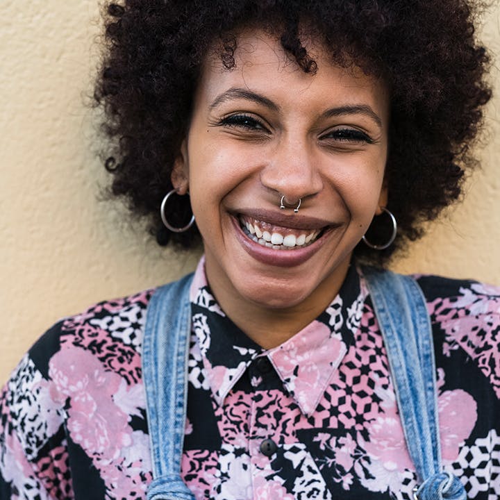 Image of a person in a patterned shirt smiling.