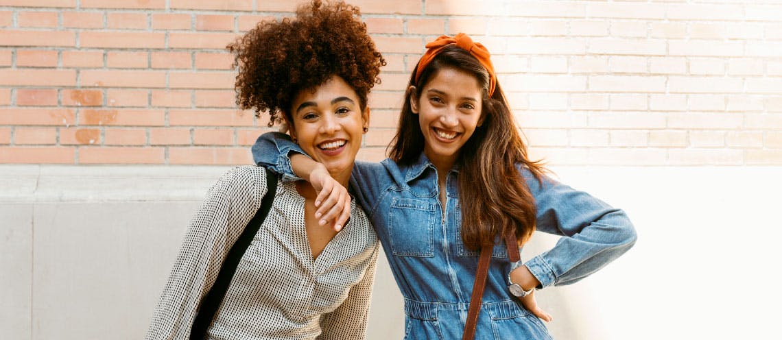 Two young women smiling.