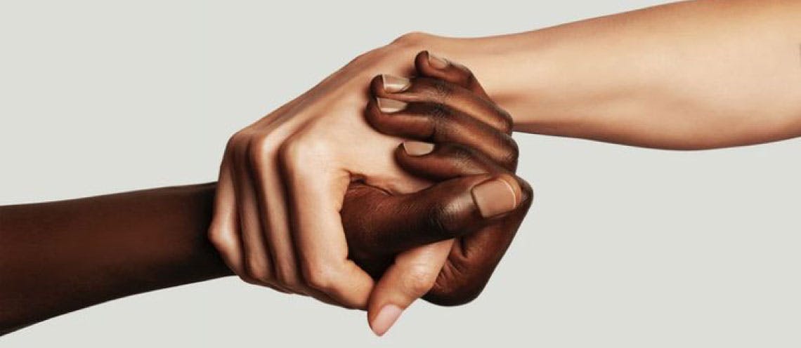 Close-up of two people holding hands