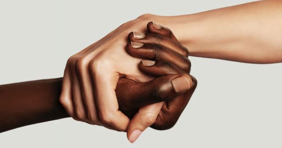 Close-up of two people holding hands
