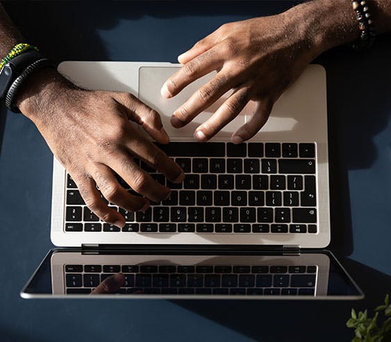 hands on an open laptop
