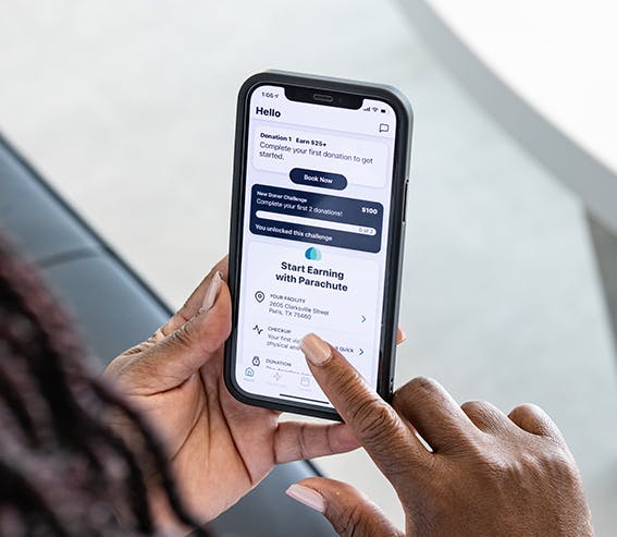 Photo of donor using Parachute app on a smartphone.