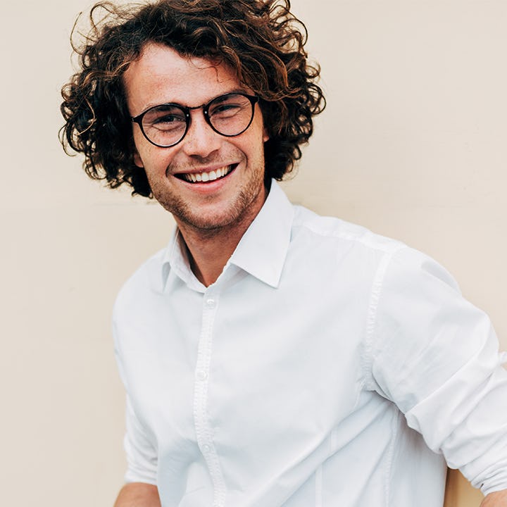 young man with glasses long hair 