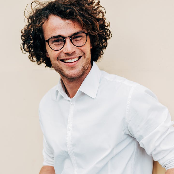 young man with glasses long hair 