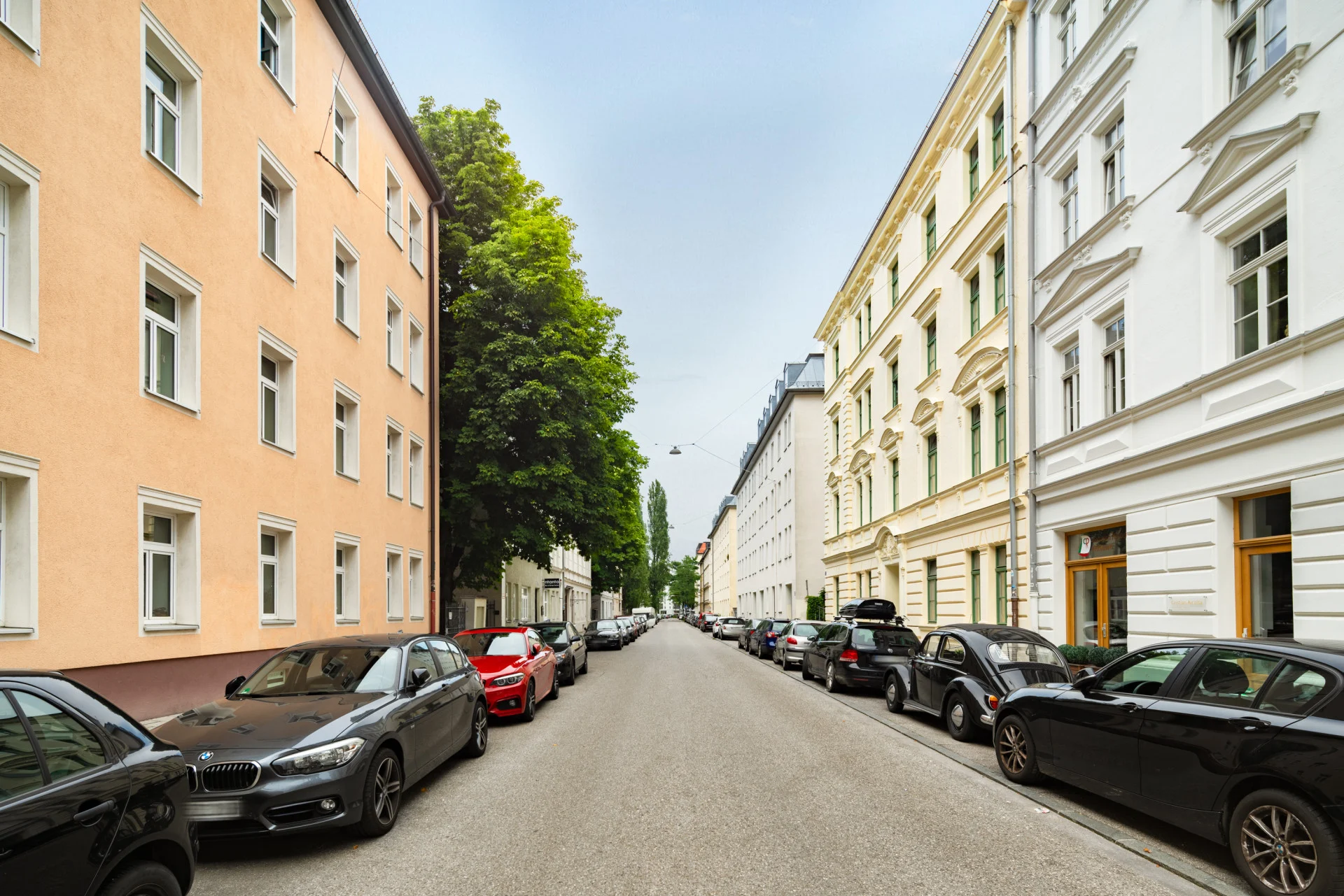 Calm street in Munich with cars parked on each side