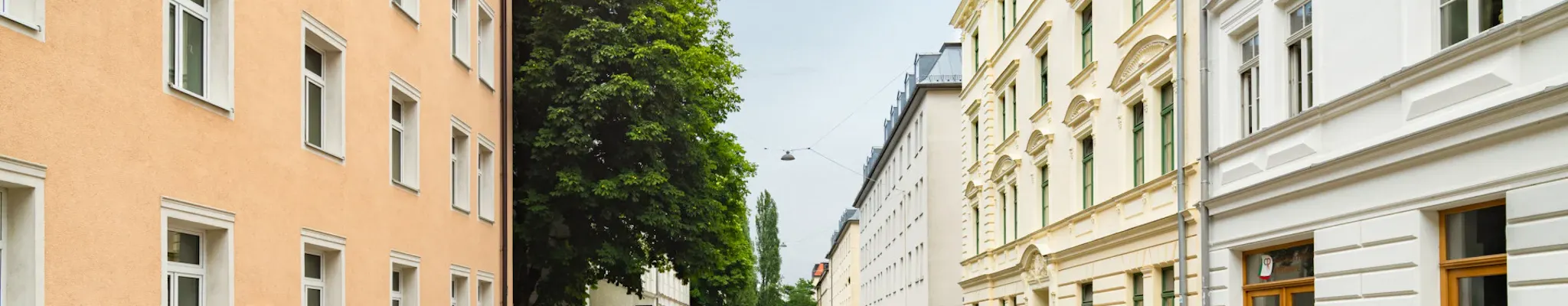 Calm street in Munich with cars parked on each side