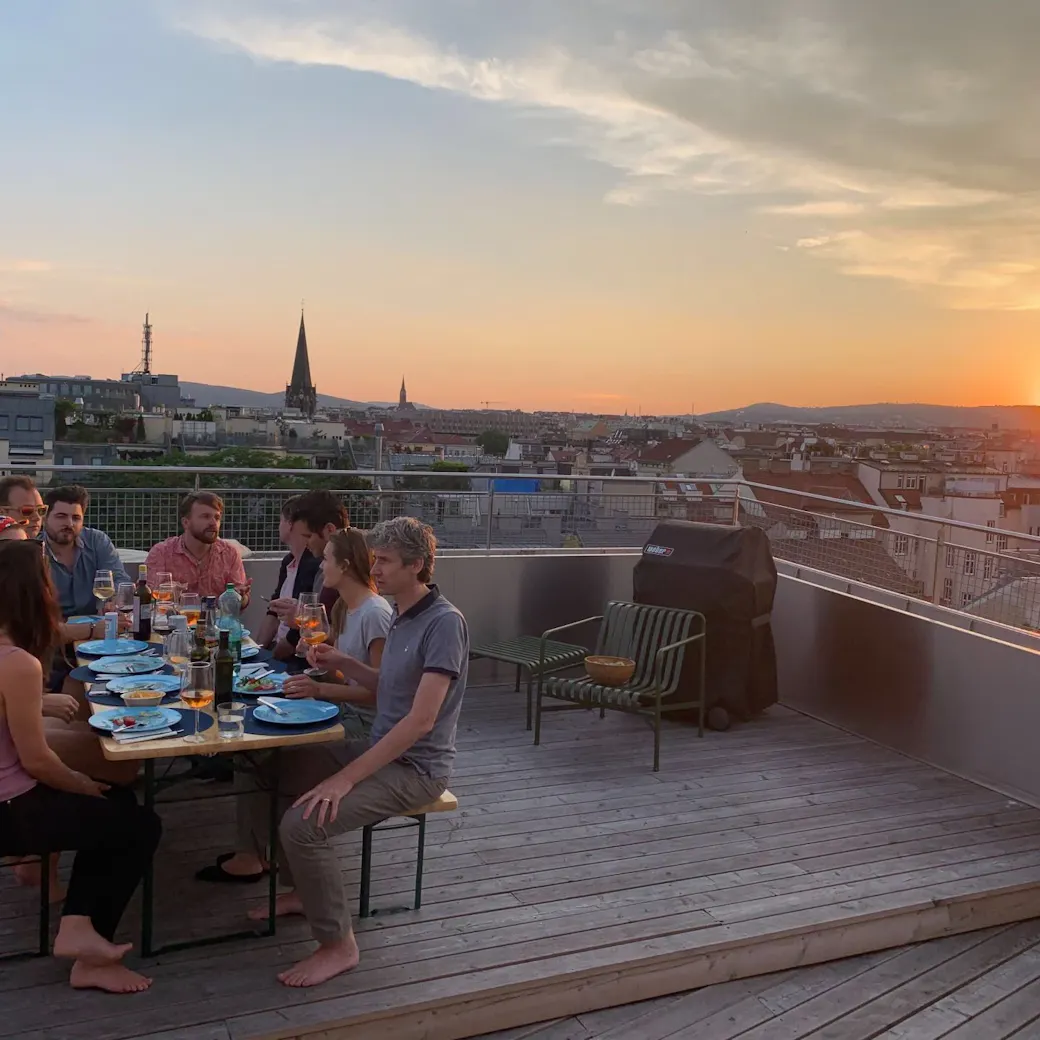 Shared dinner on the rooftop terrace of a LifeX coliving apartment