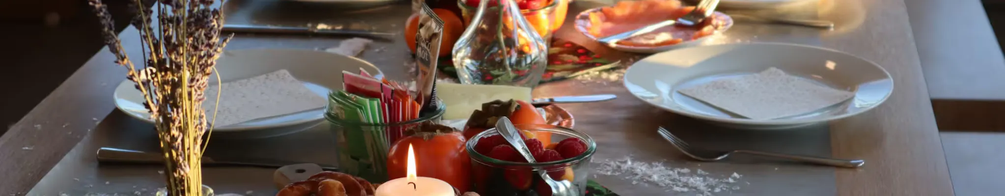 Prepared dinner table with cozy decoration and candles