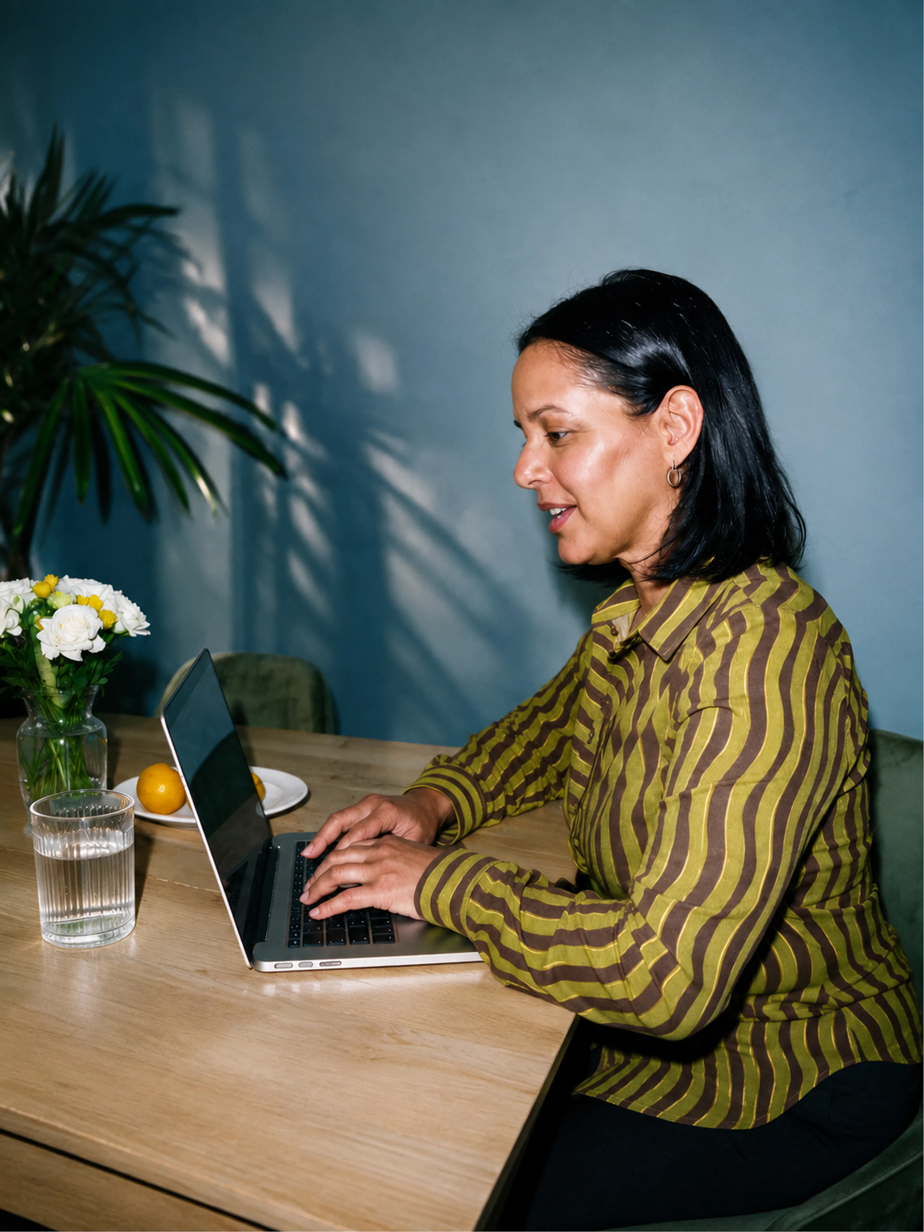 Woman typing on laptop at table