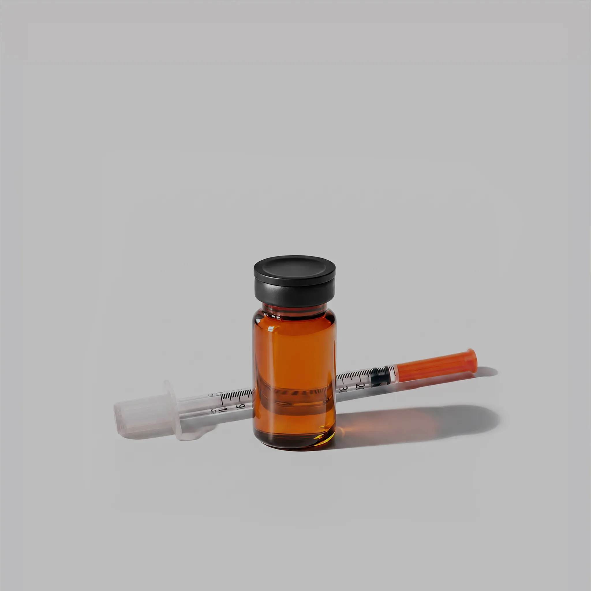 Amber glass vial beside thin syringe
