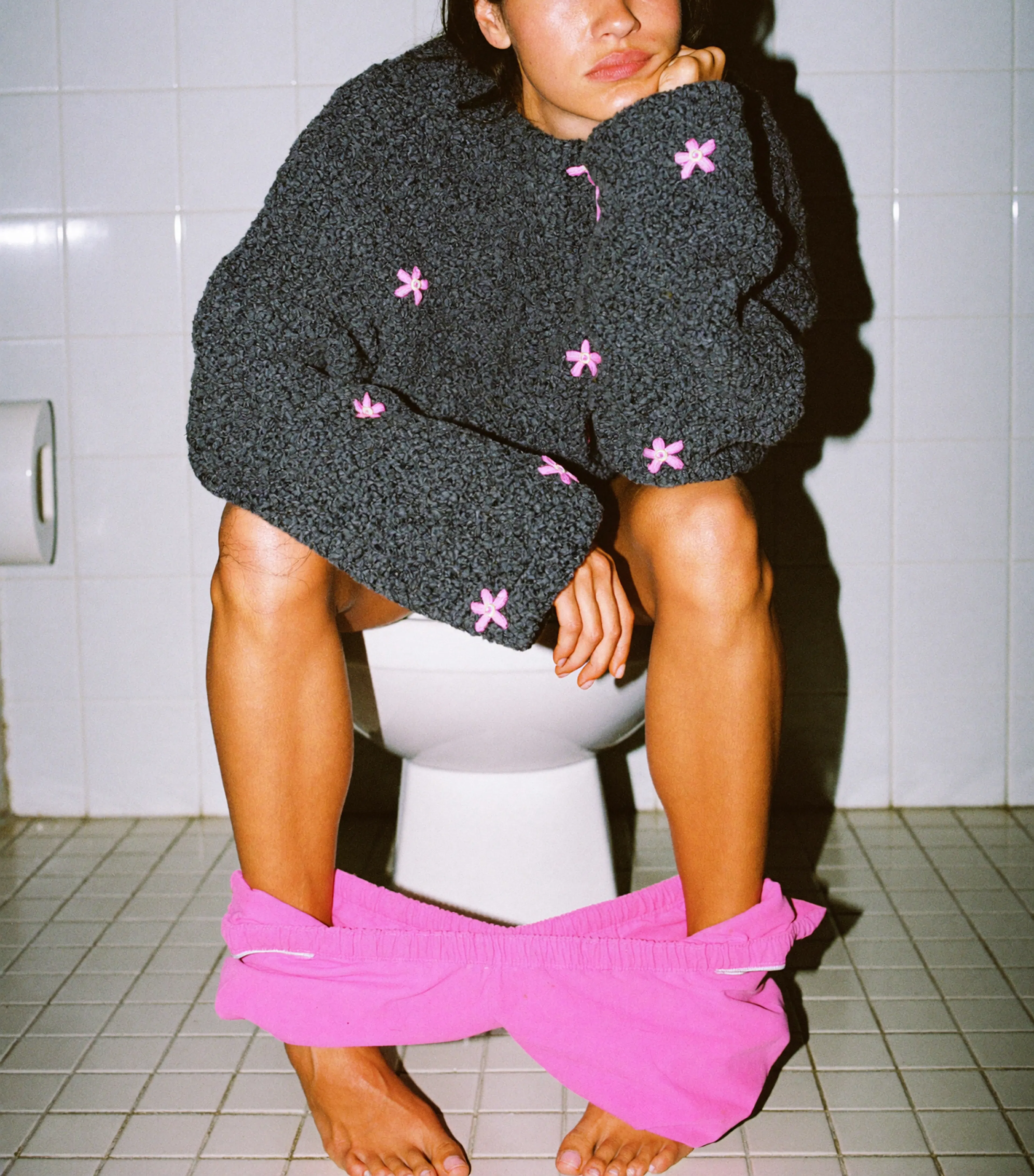 Woman on toilet suffering from periods