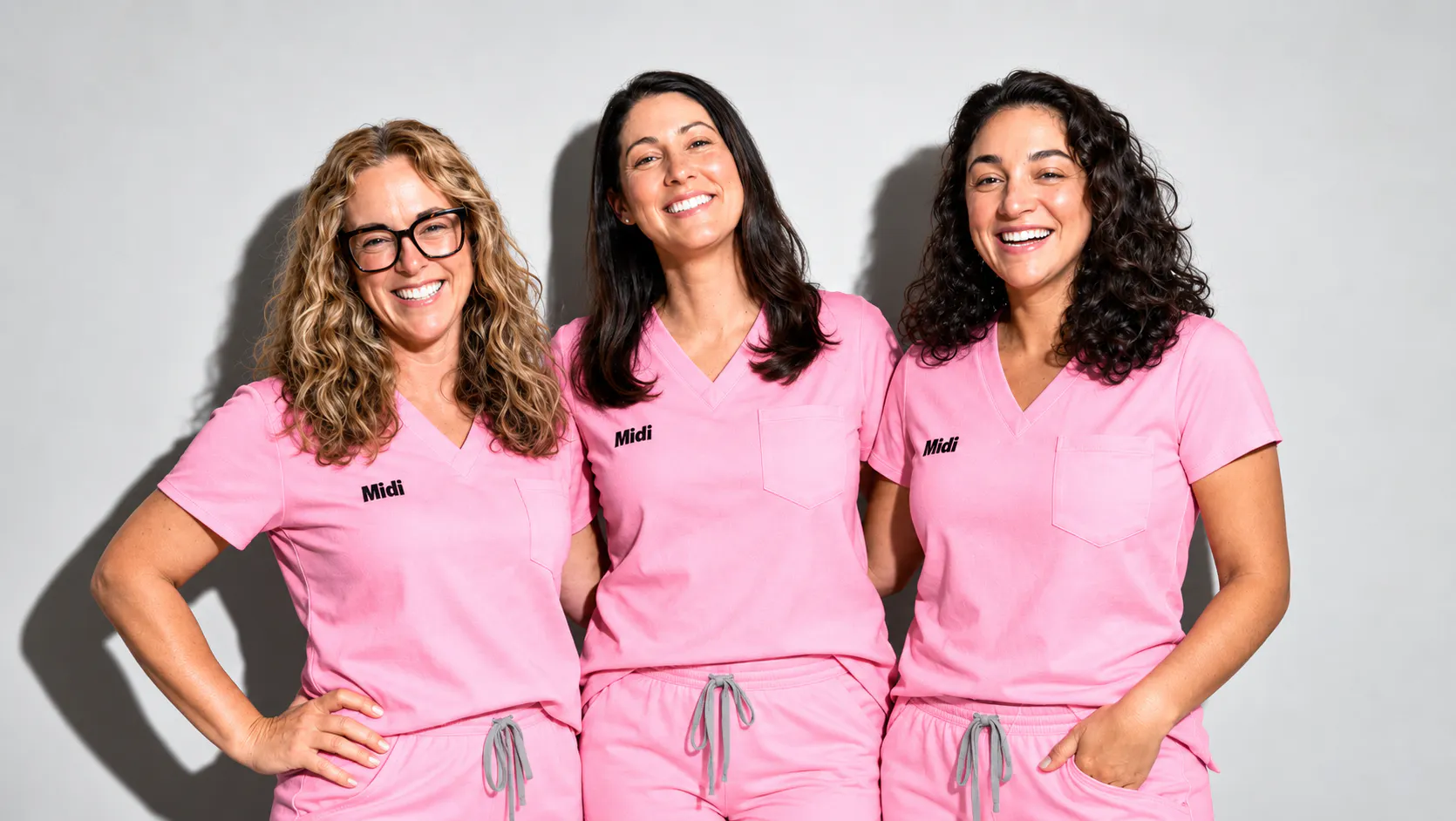 3 clinicians in pink scrubs