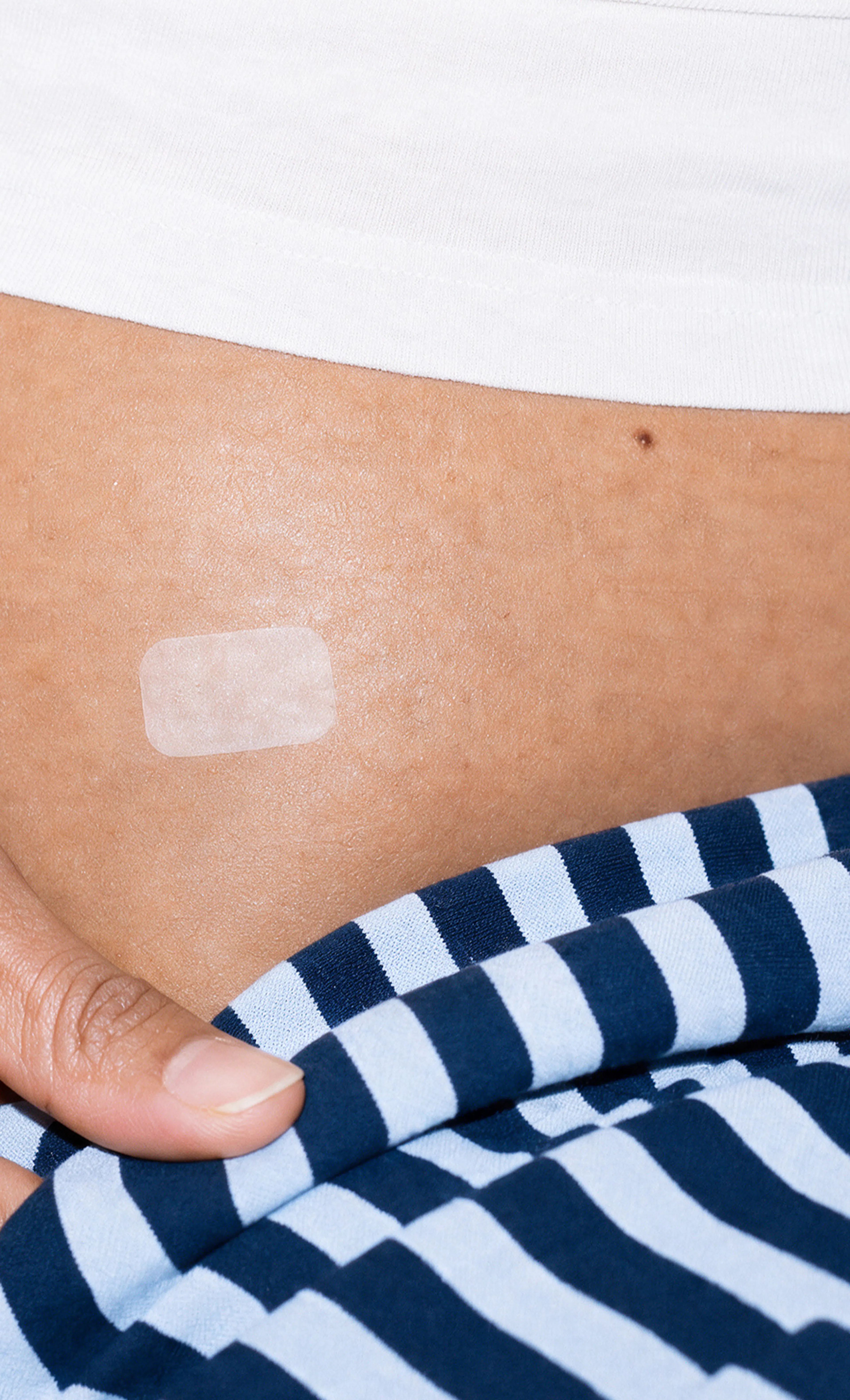 Small medical patch on person's skin
