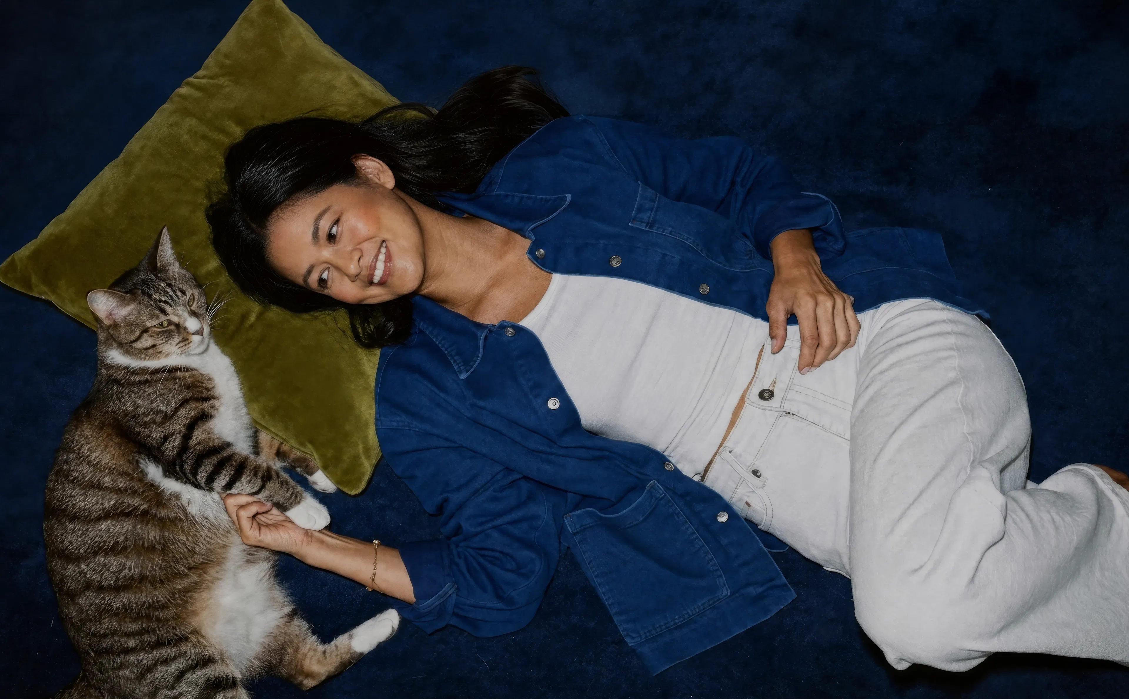 woman lying down with cat