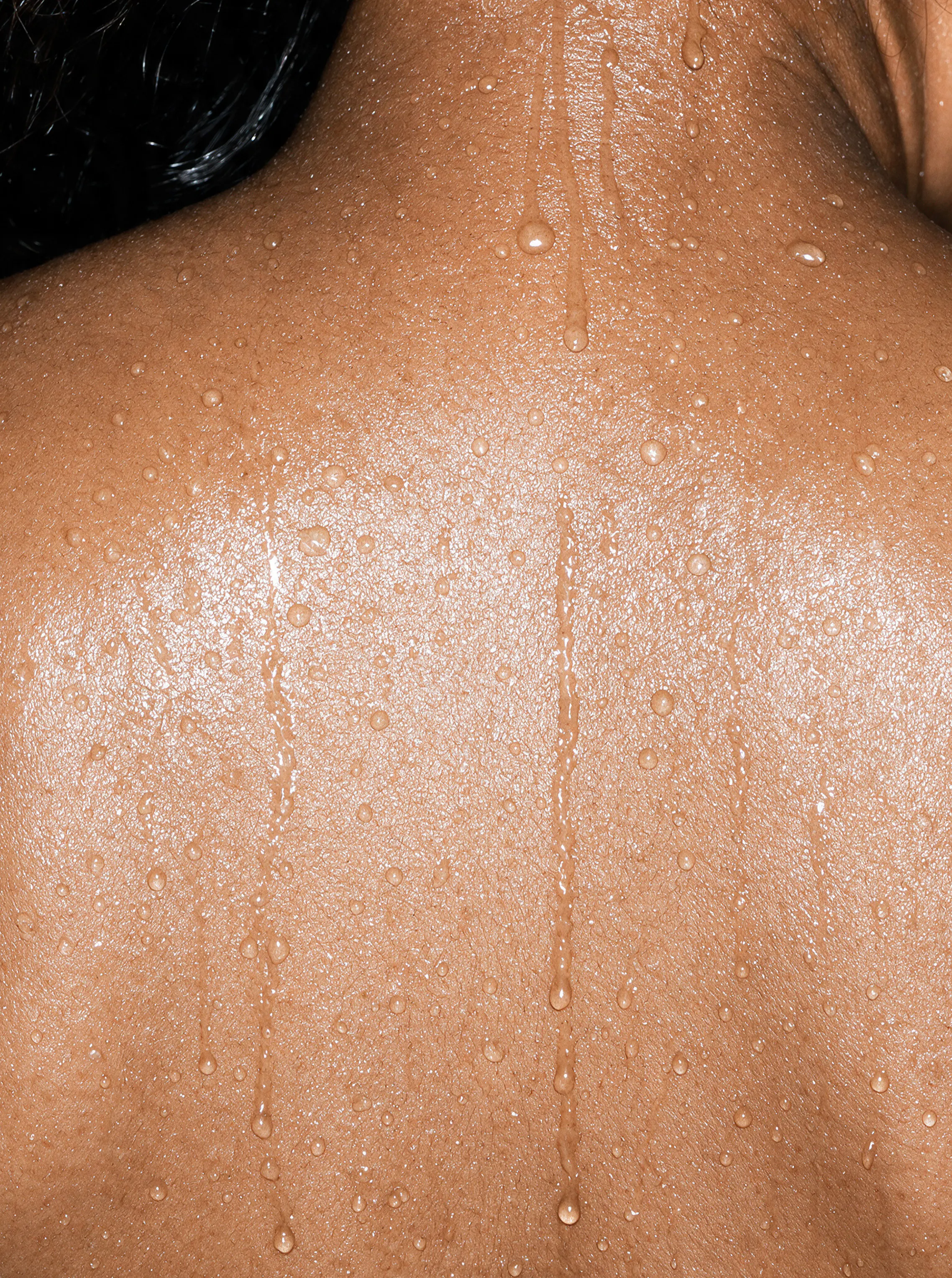Person's back showing visible perspiration