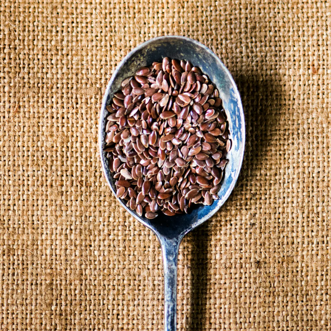 A close-up photo of flaxseeds, a well-evidenced supplement to lower cholesterol