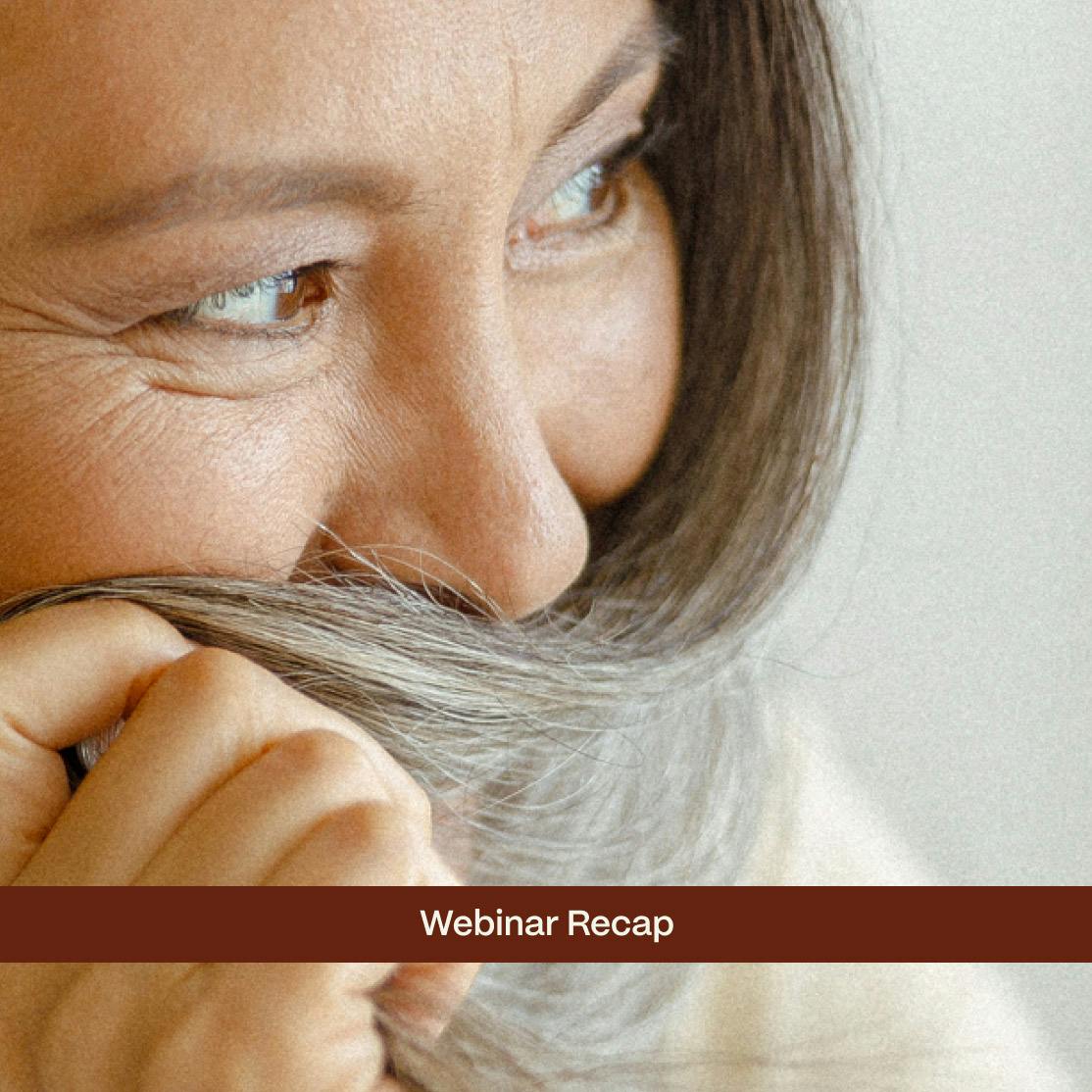 woman smiling behind her hair