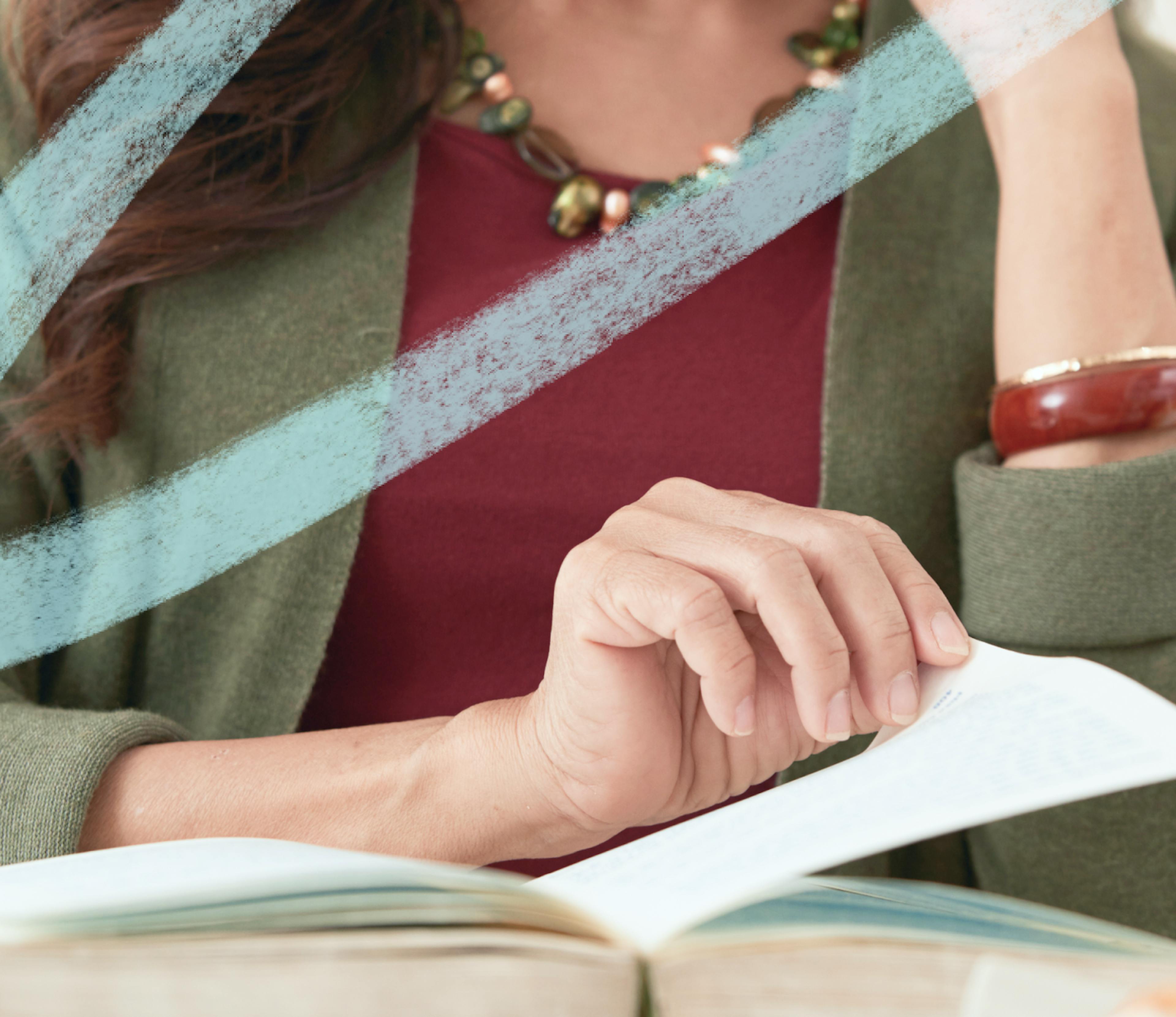 image of a woman's hand on an open book