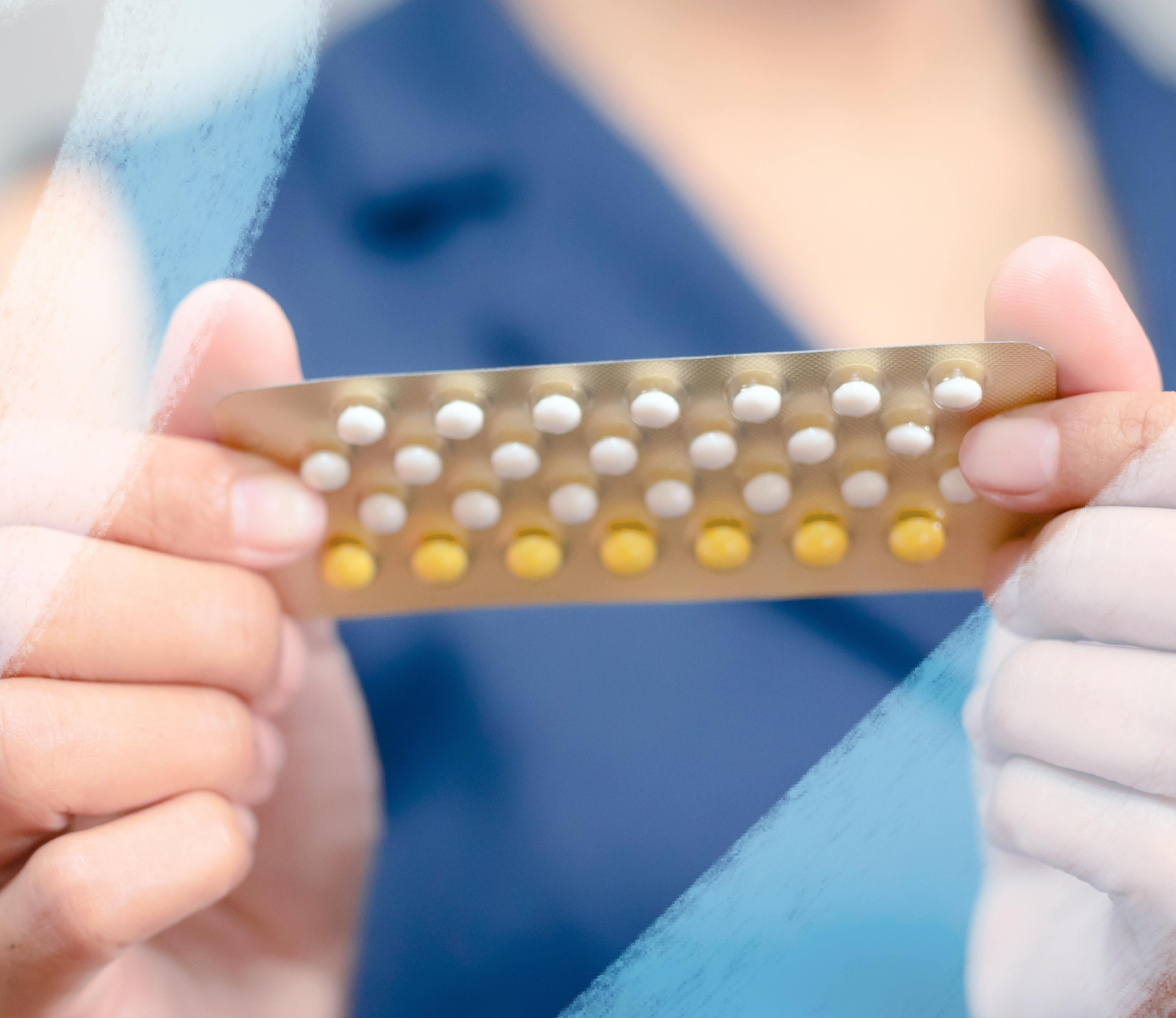 person holding birth control pill pack in hands