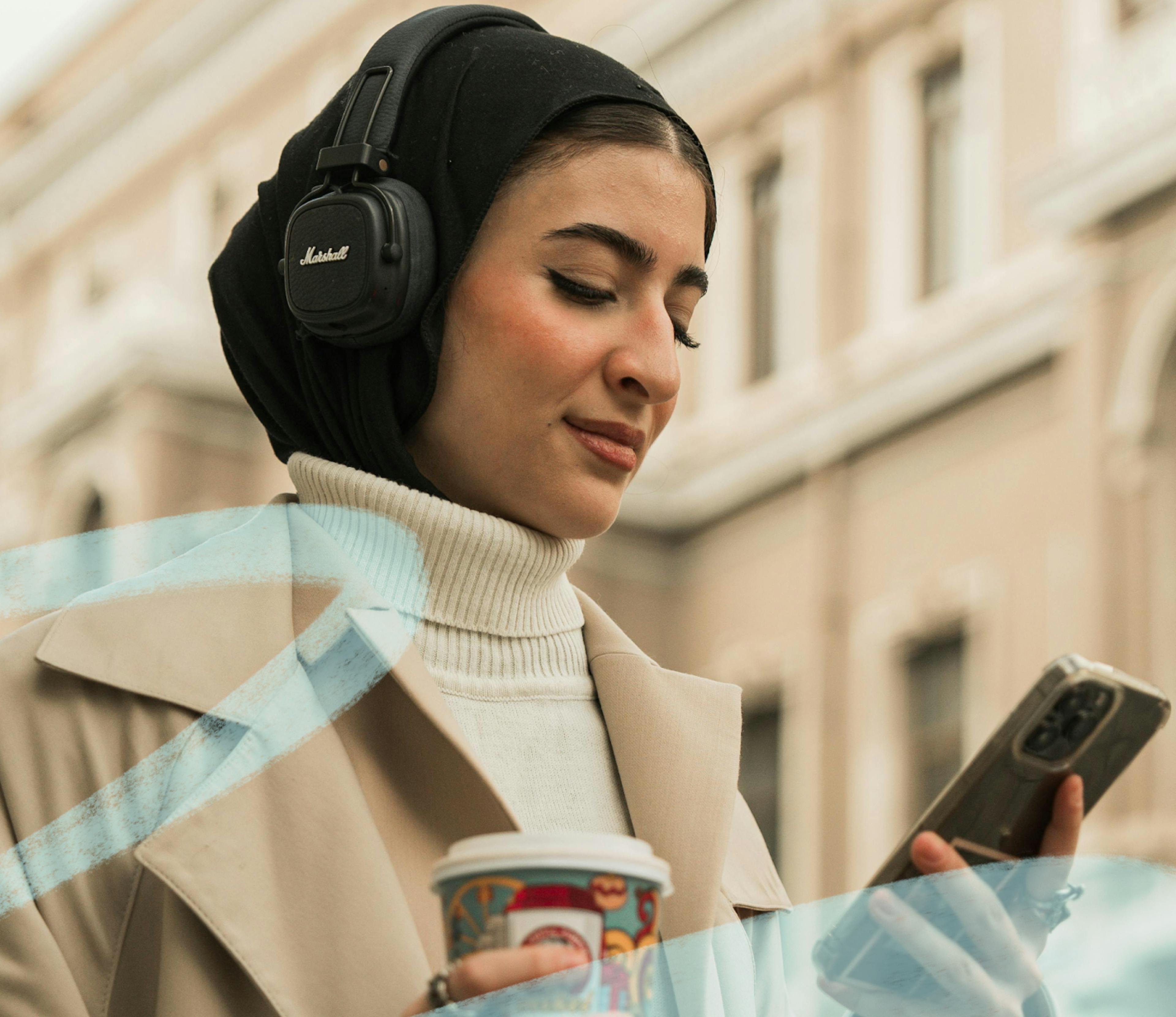 woman wearing headphones looking at device