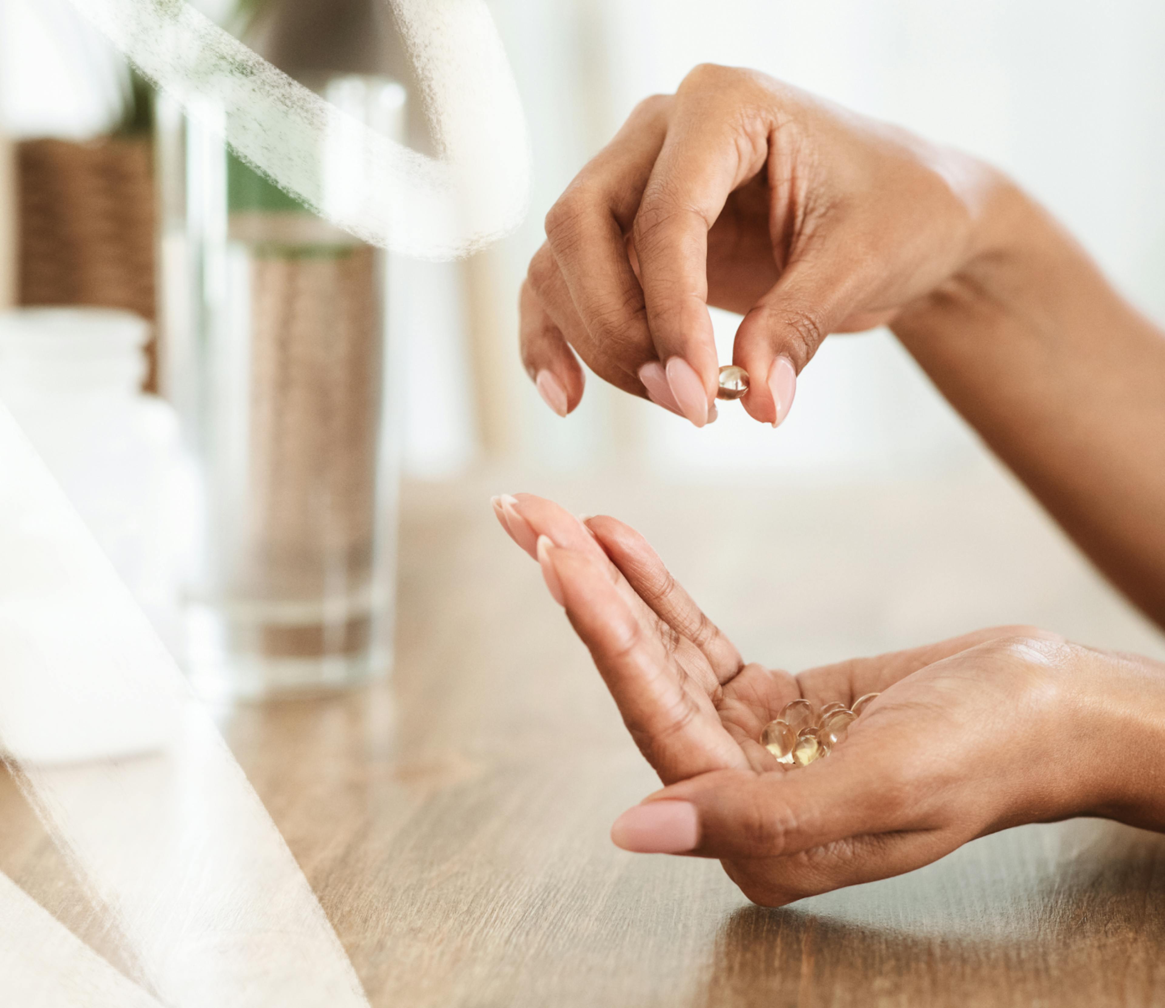 Photo of a person's hands with vitamins in them