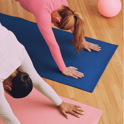 Photograph of two women doing yoga
