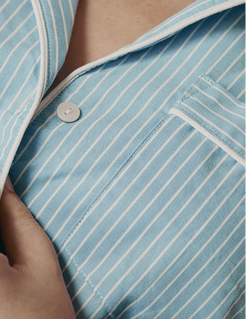 Close cropped photograph of woman wearing striped pajamas