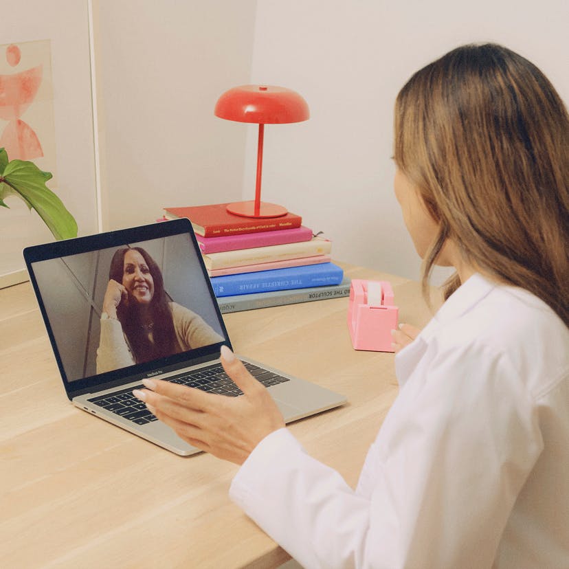 Photograph of Midi clinician on a laptop interacting with patient via telehealth