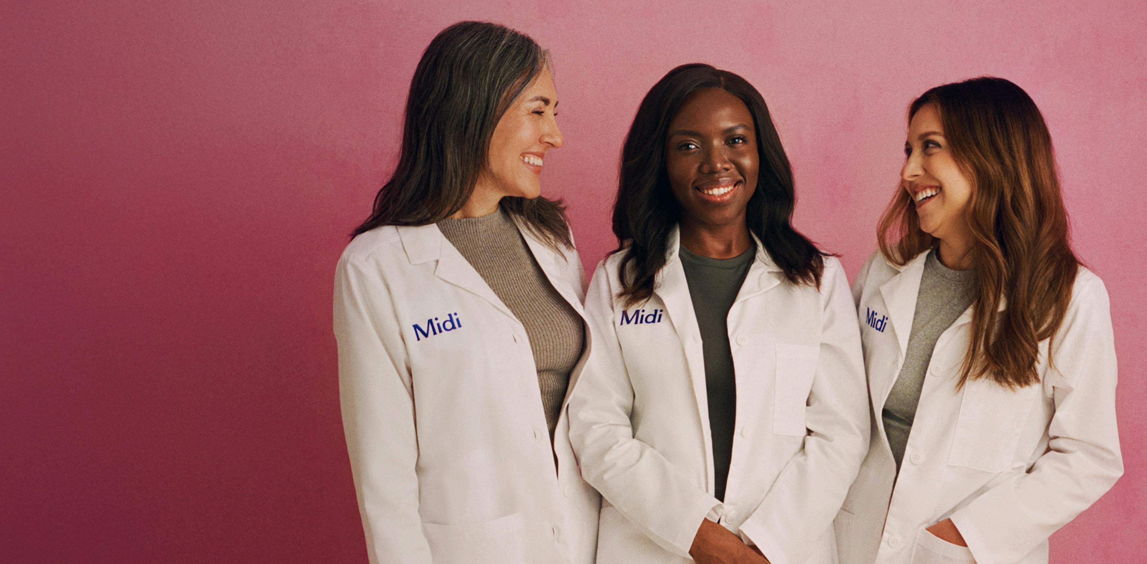 Photograph of three Midi clinicians in uniform, standing in front of a pink background.