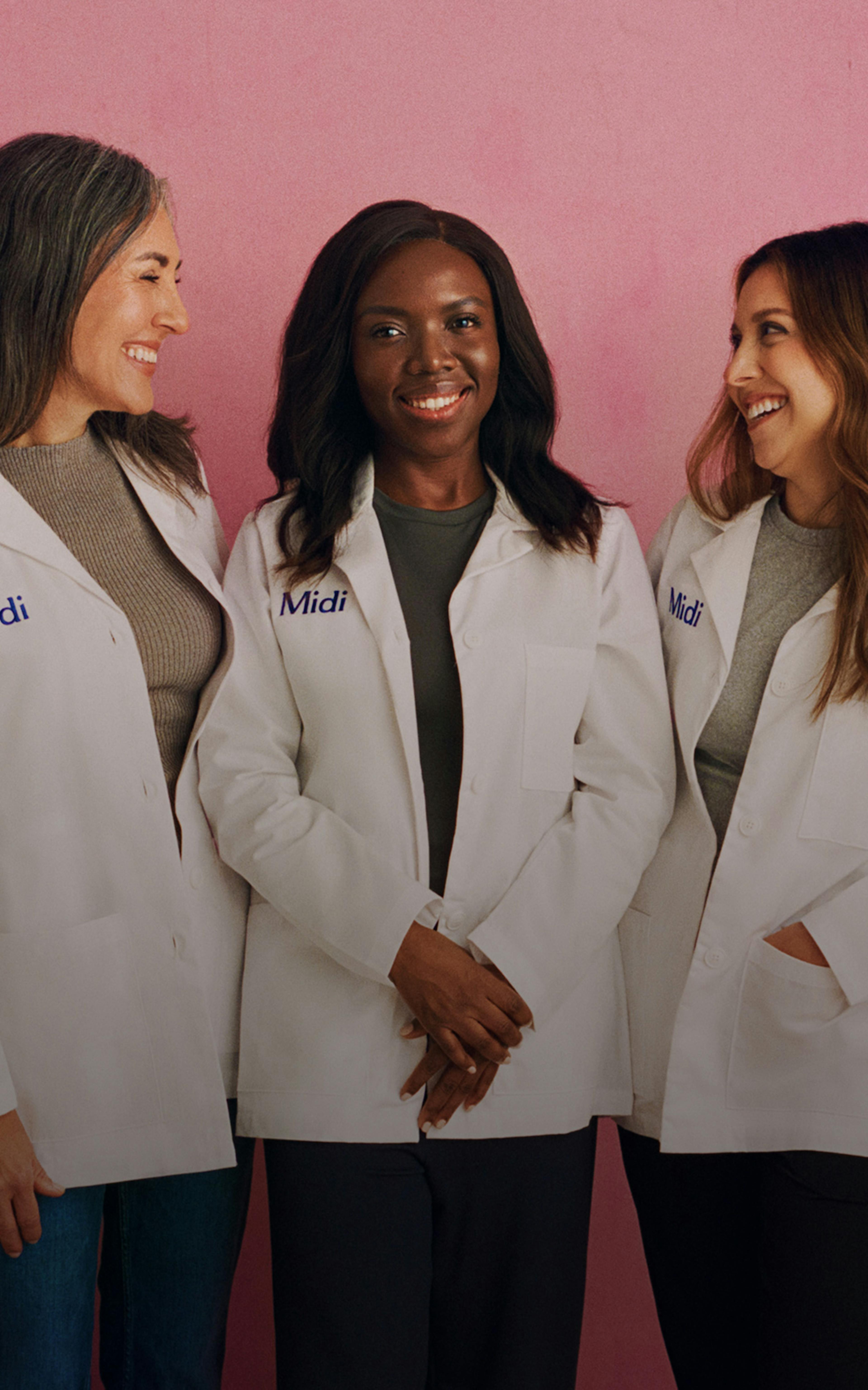 Photograph of three Midi clinicians in uniform, standing in front of a pink background.