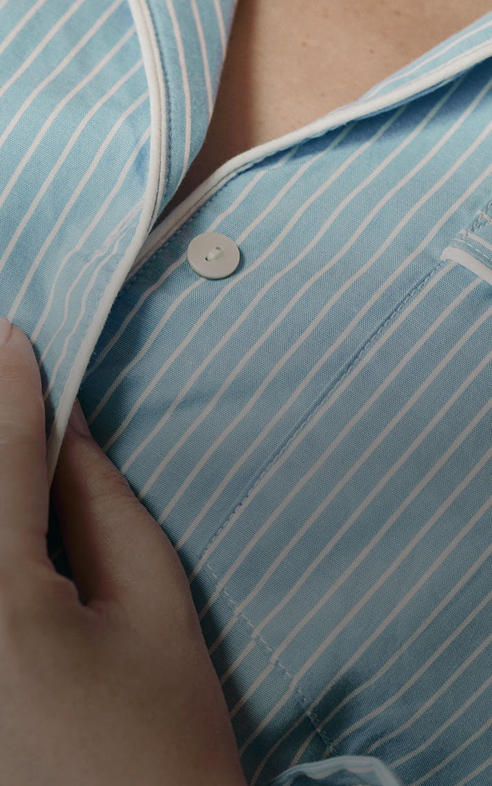 Close cropped photograph of woman wearing striped pajamas