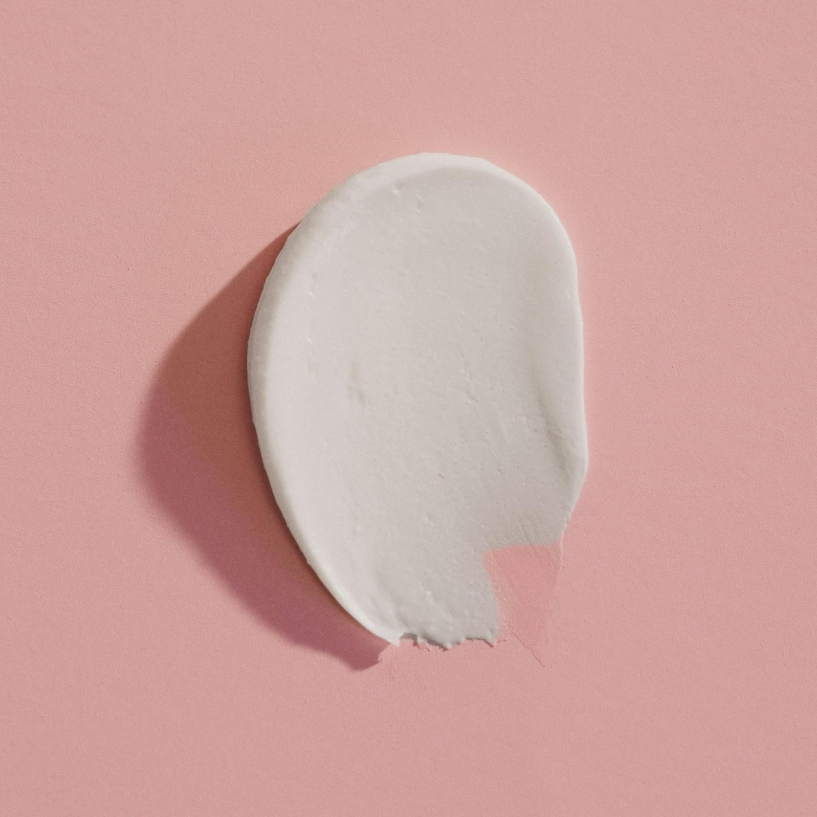 Cream on a pink background