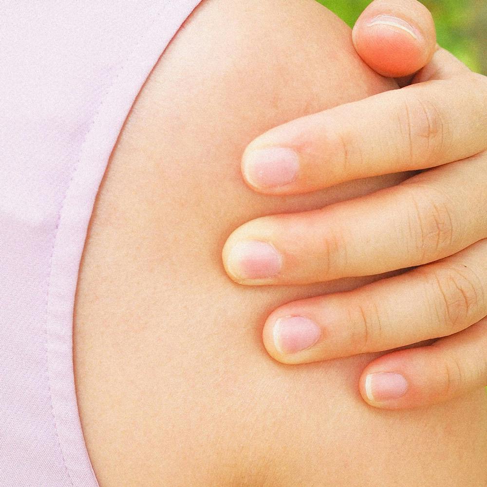 Woman's hand on outside of shoulder