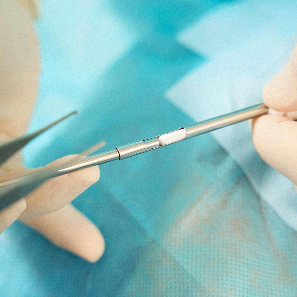 Closely cropped image of doctor holding a hormone pellet