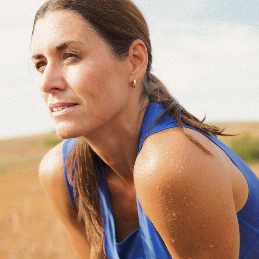 Woman sweating after exercise, looking to the distance