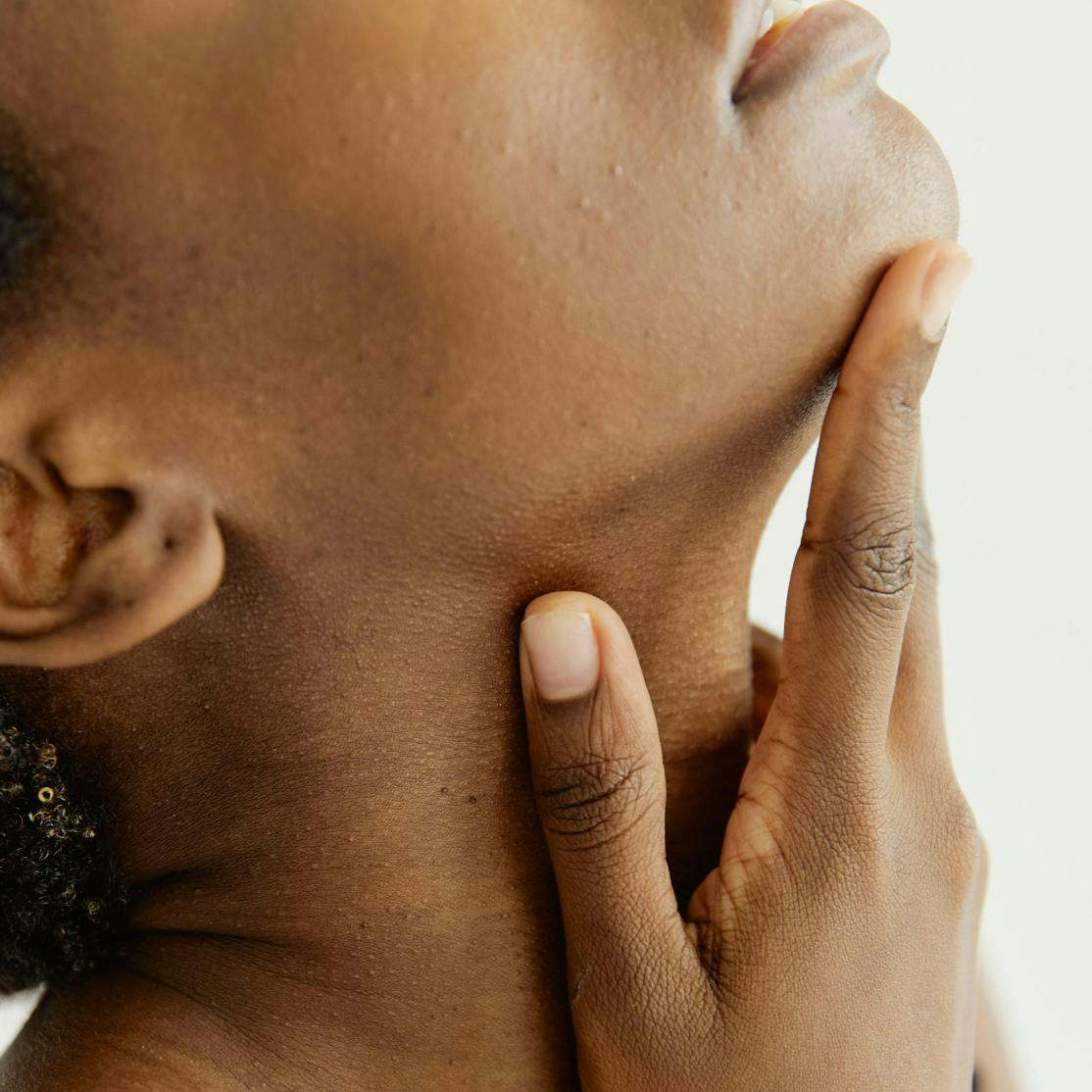 woman touching neck