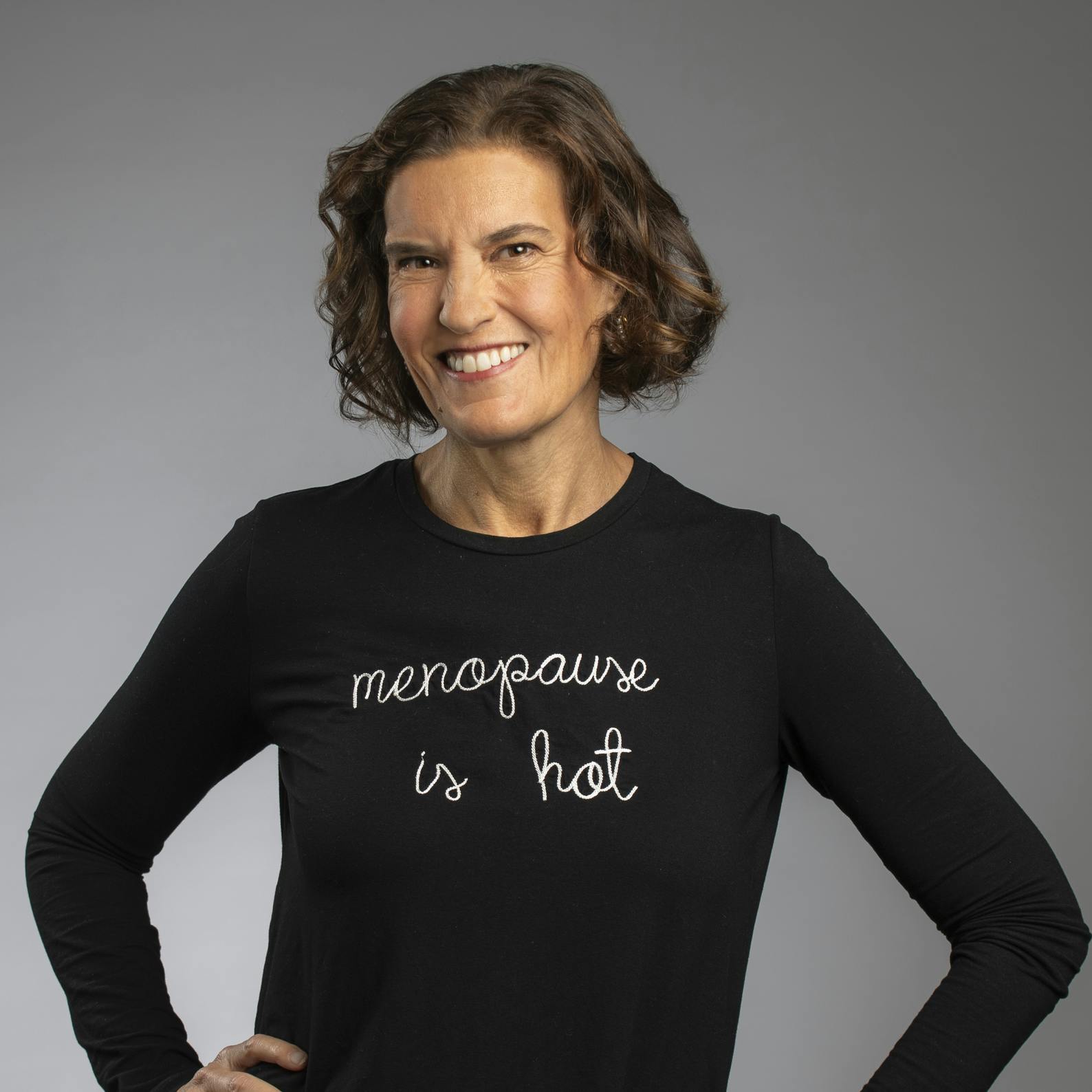 Midi's CEO Joanna Strober wearing a black shirt that reads, "Menopause Is Hot"
