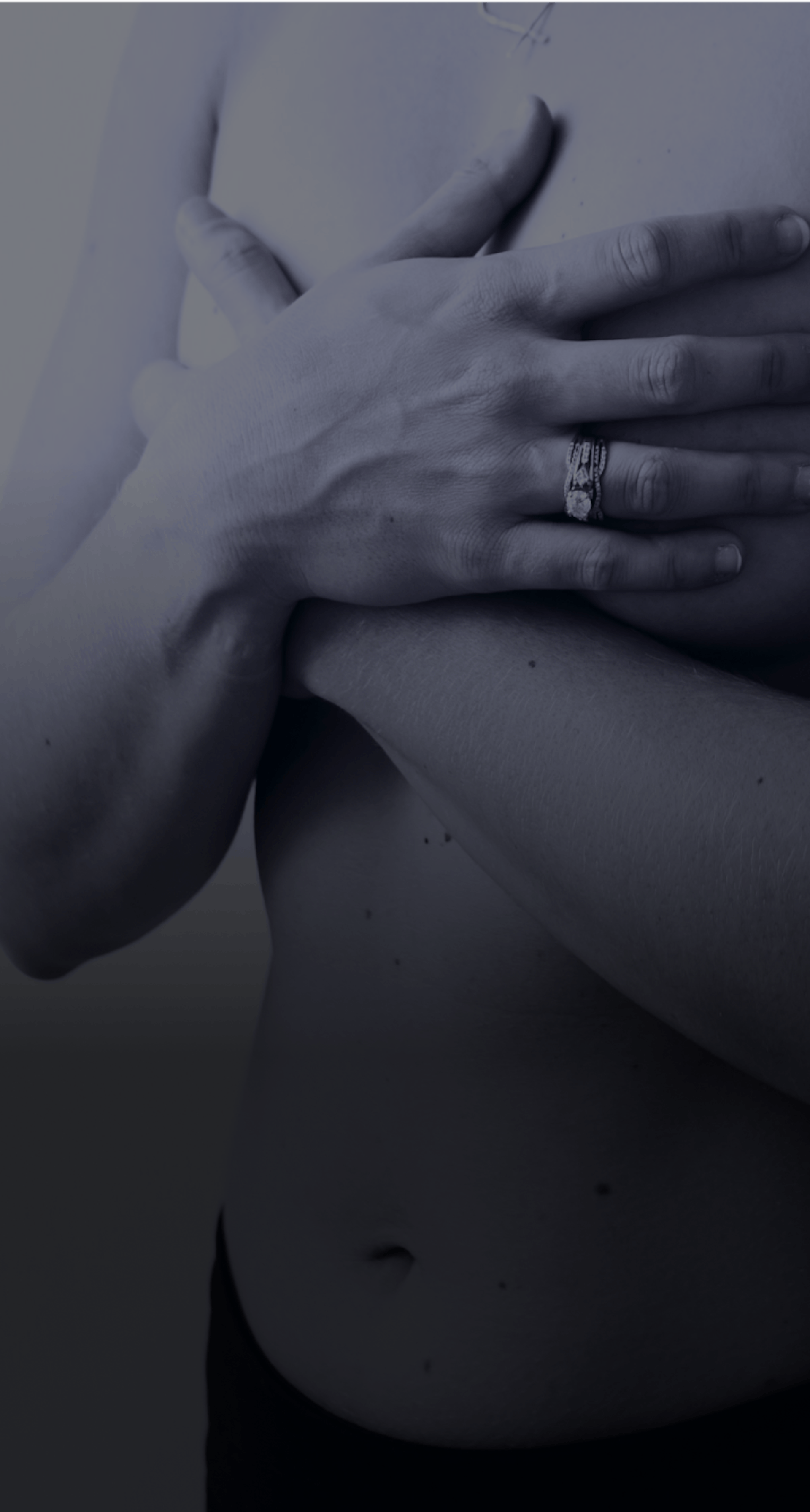 Woman's hands covering breasts