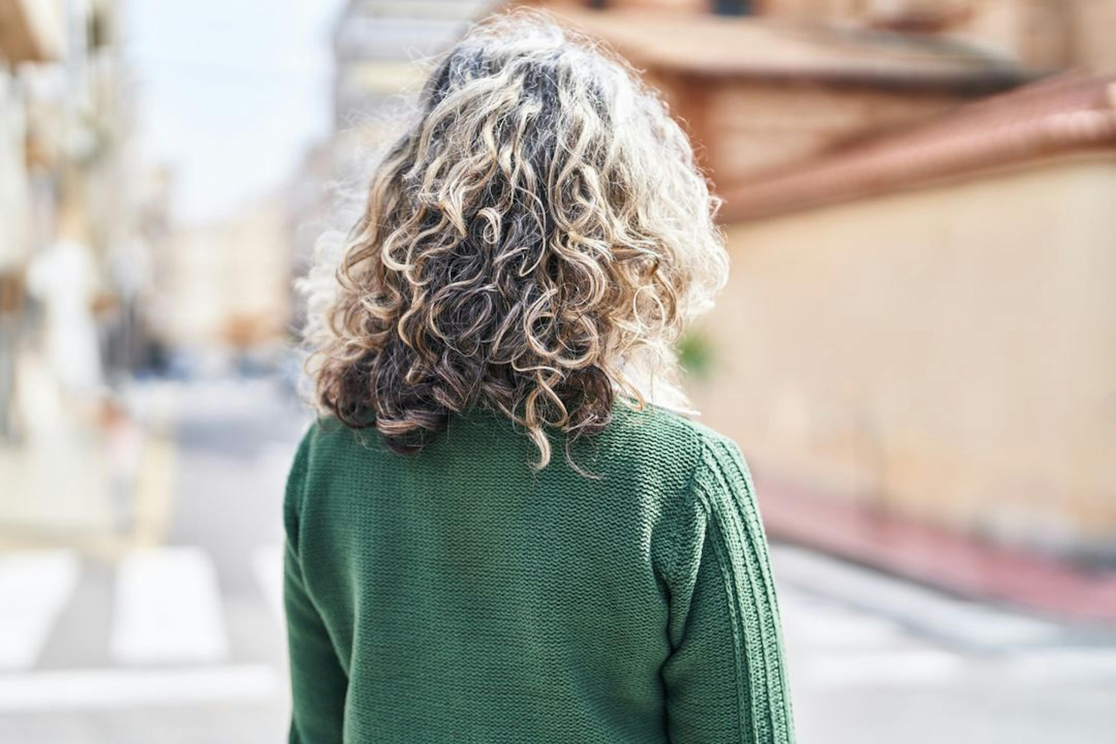 Woman with curly hair looking away