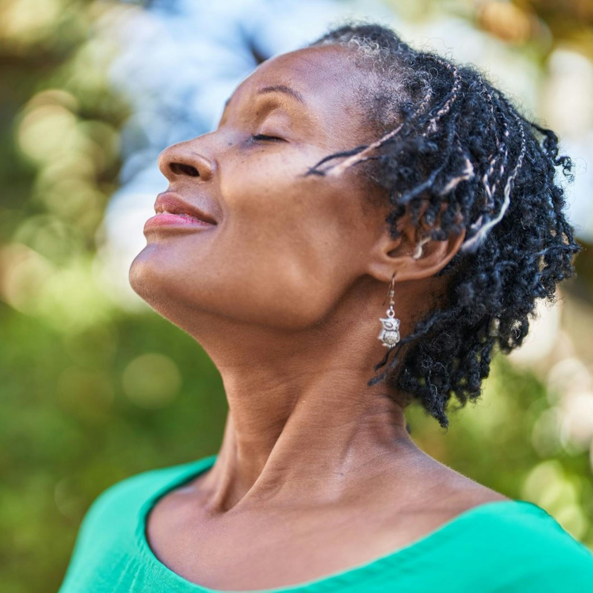 Woman looking up to the sky and smiling