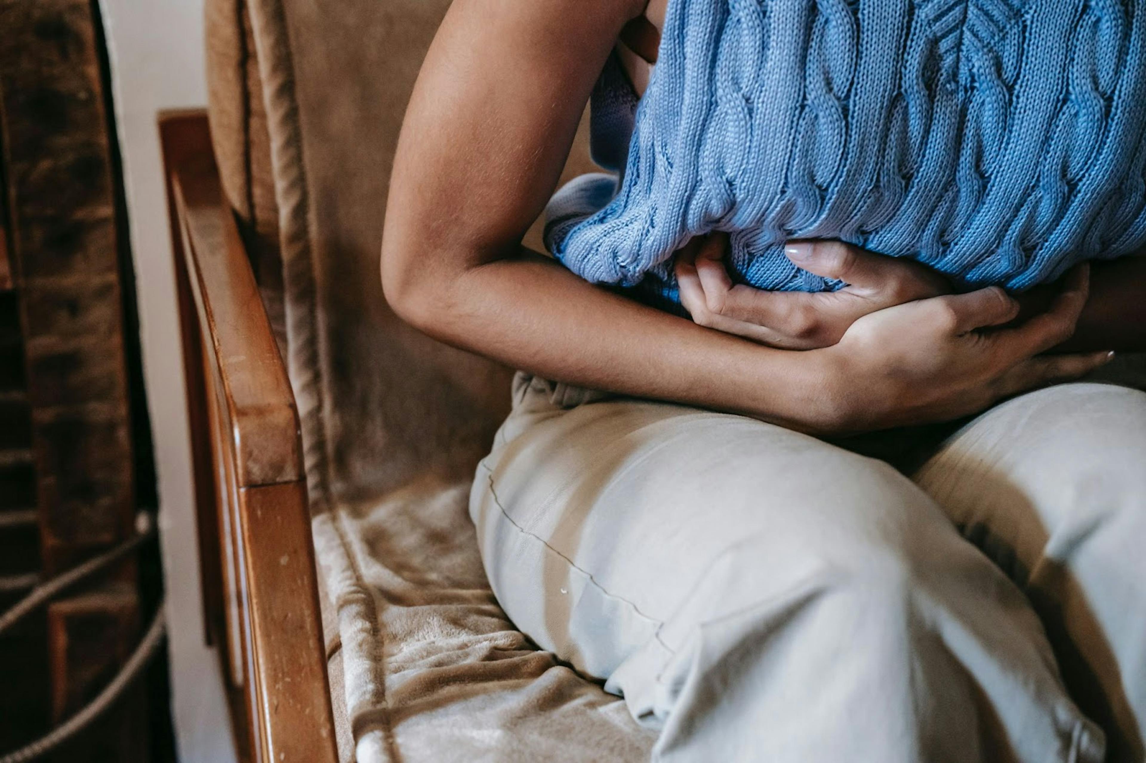 close up showing a woman's arms wrapped around her stomach