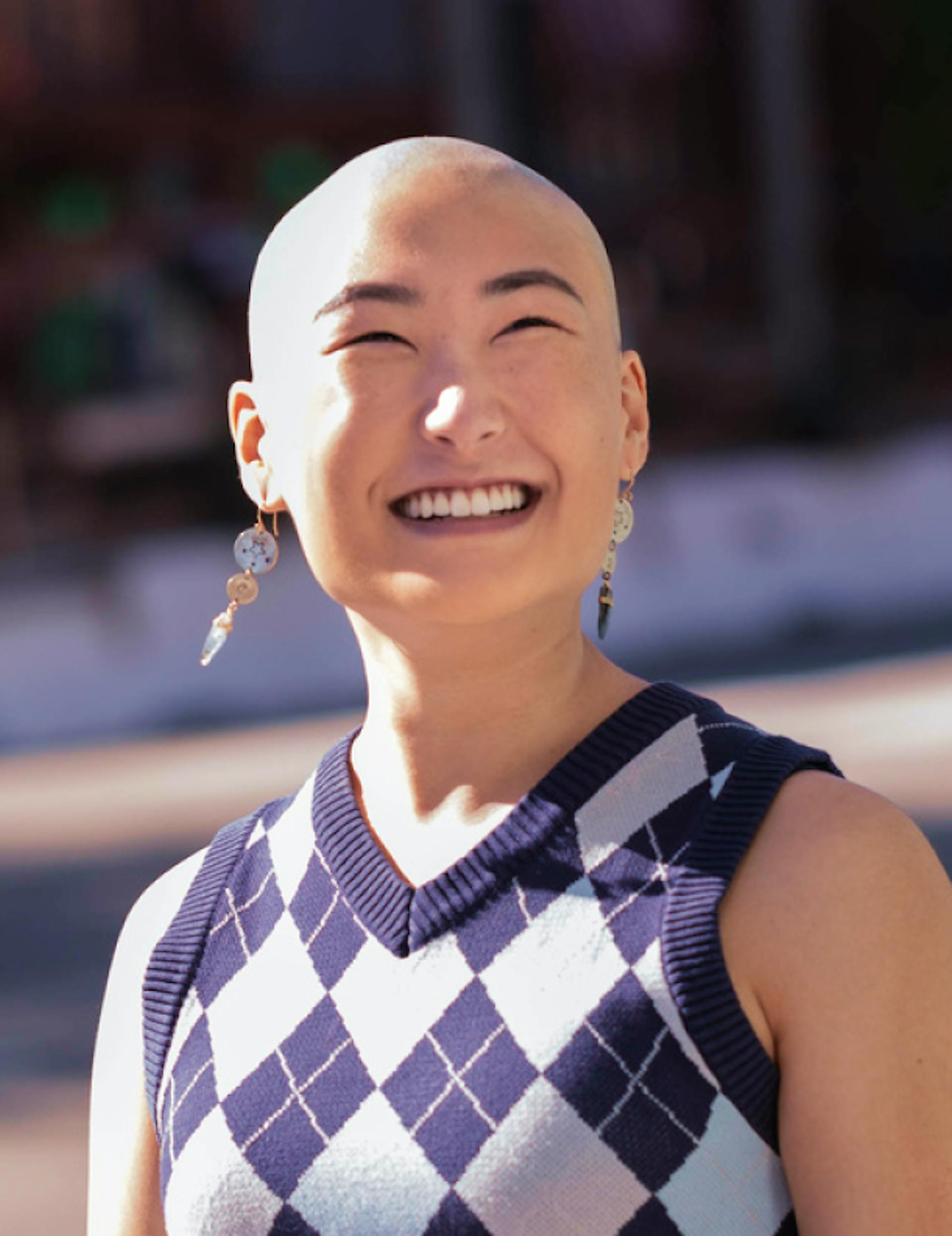 woman with a bald head smiling