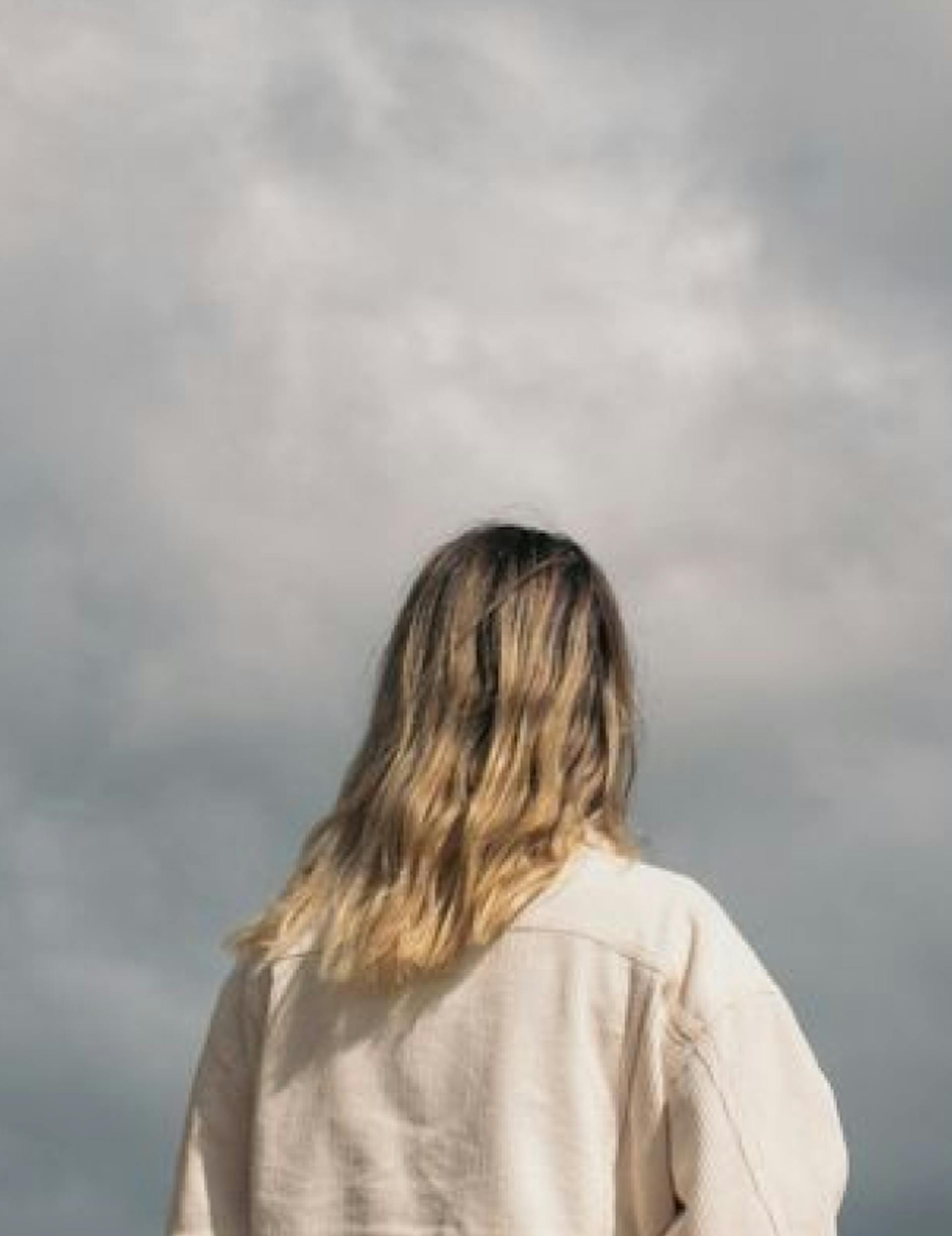 woman looking at storm clouds