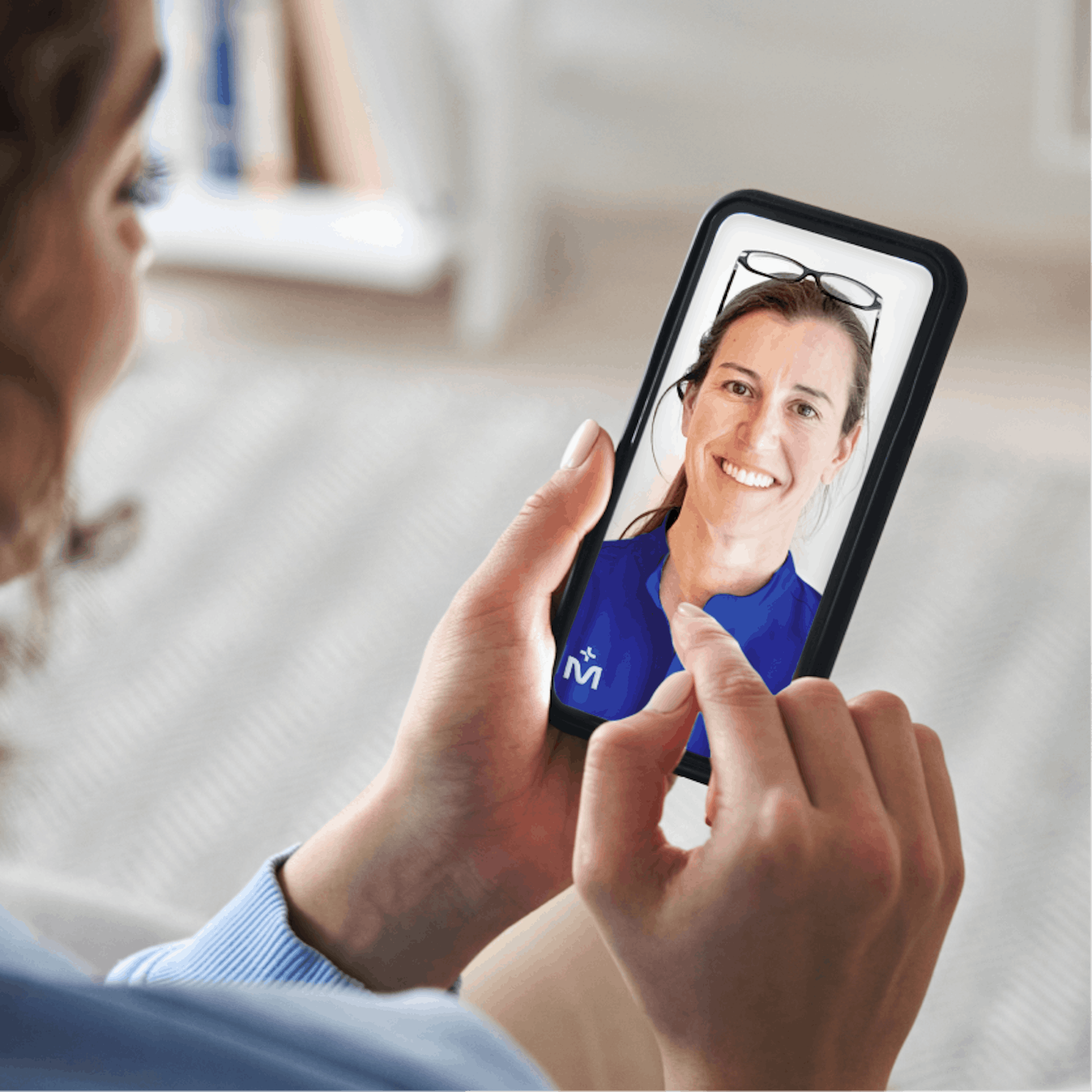 woman looking at her phone screen