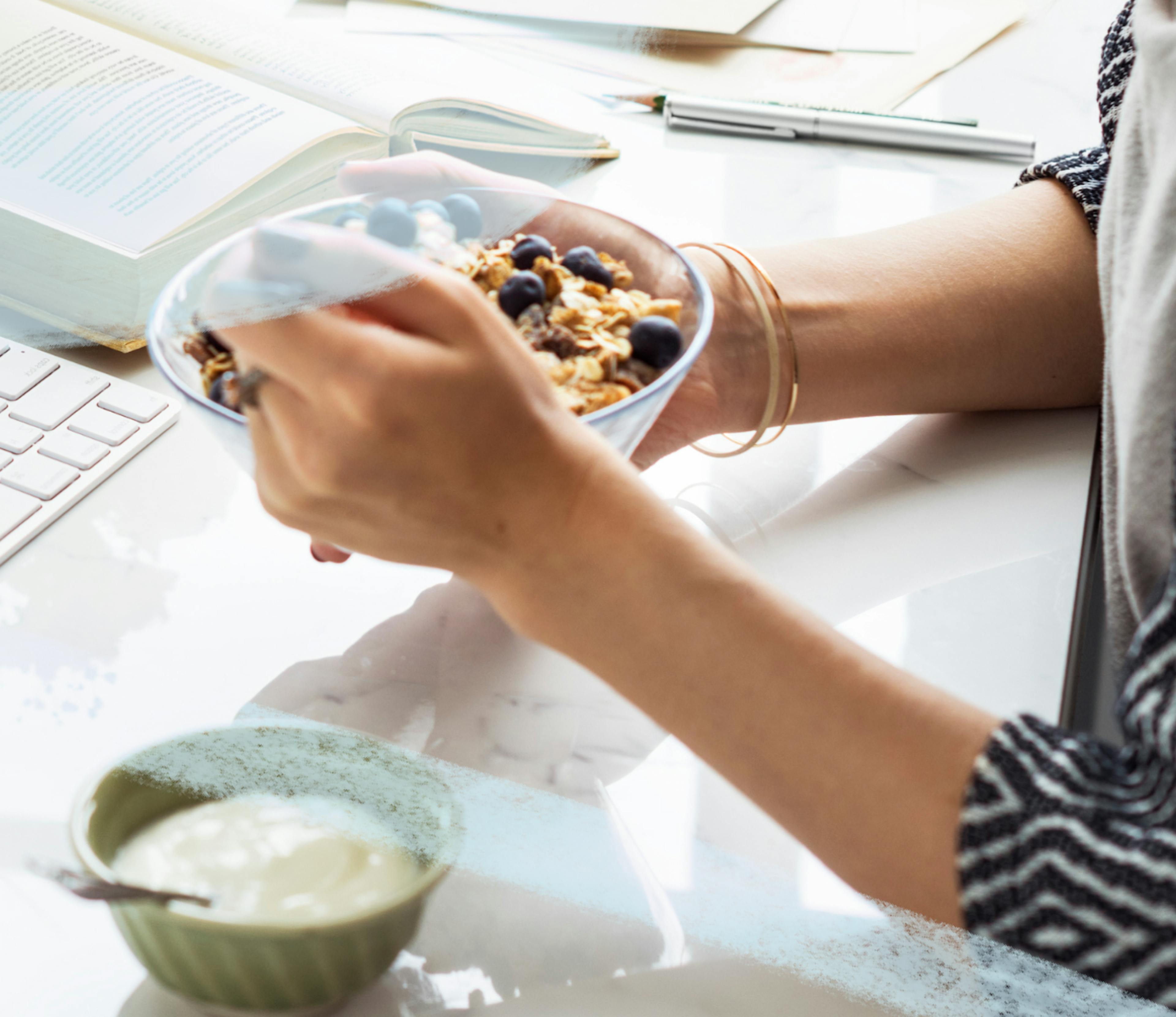 woman's hands holding a bowl of cereal