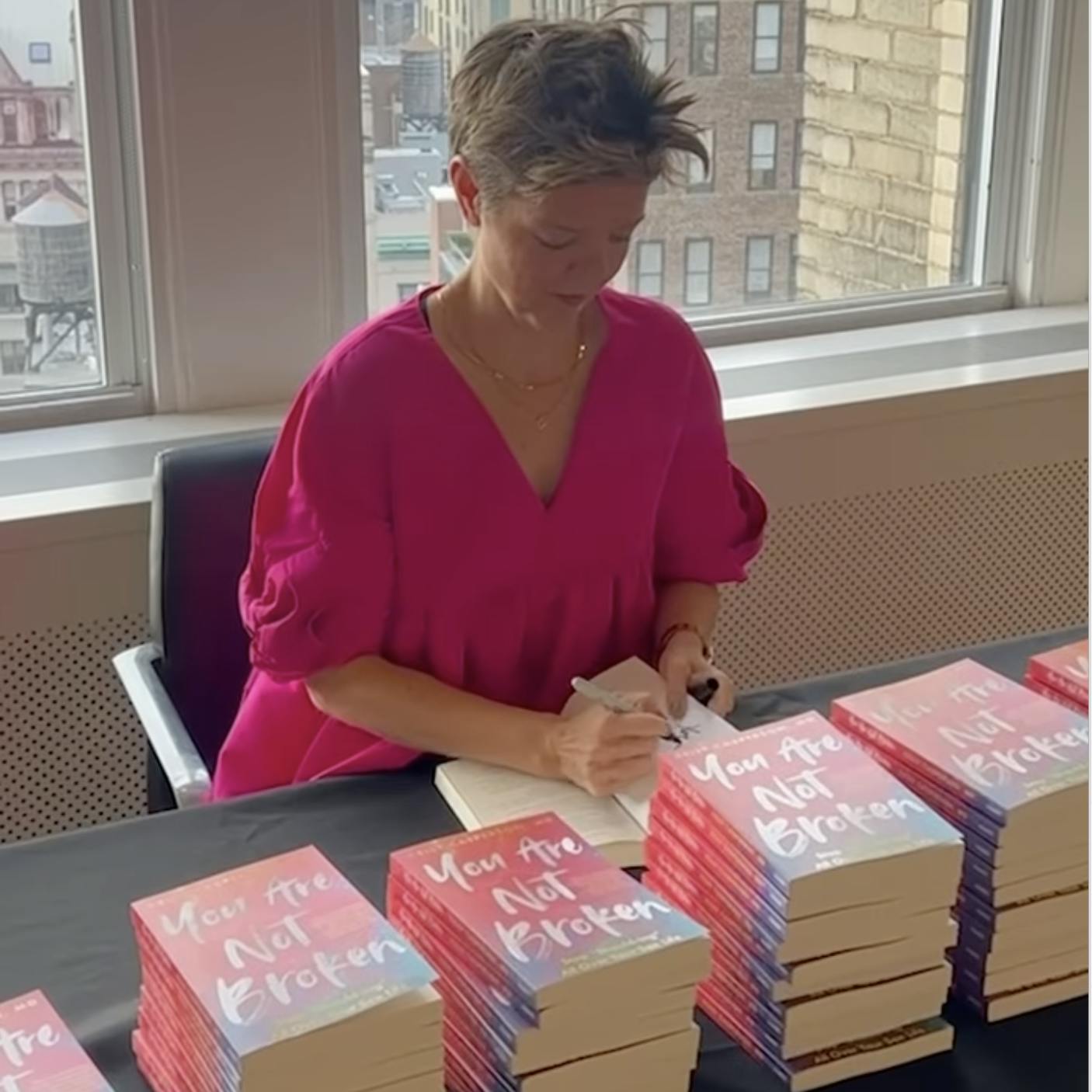 Dr. Kelly Casperson signing copies of her book, You are Not Broken