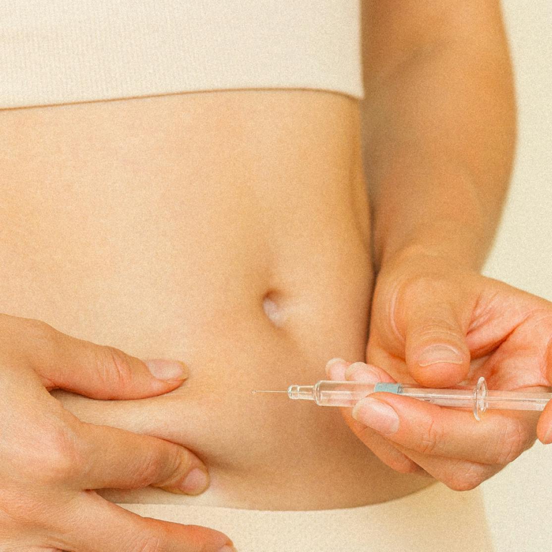 woman injecting herself with a needle