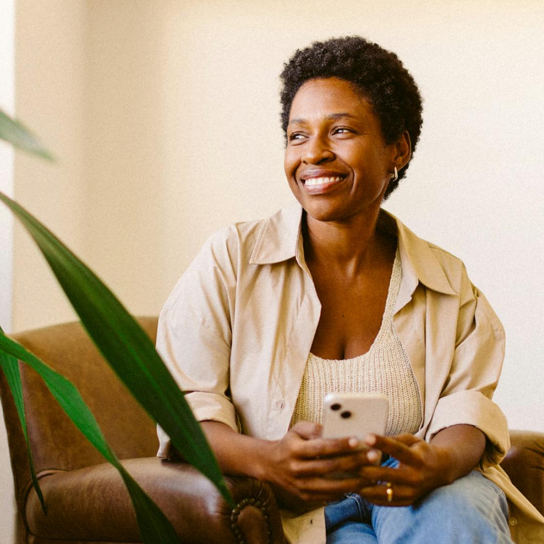 woman smiling holding a phone