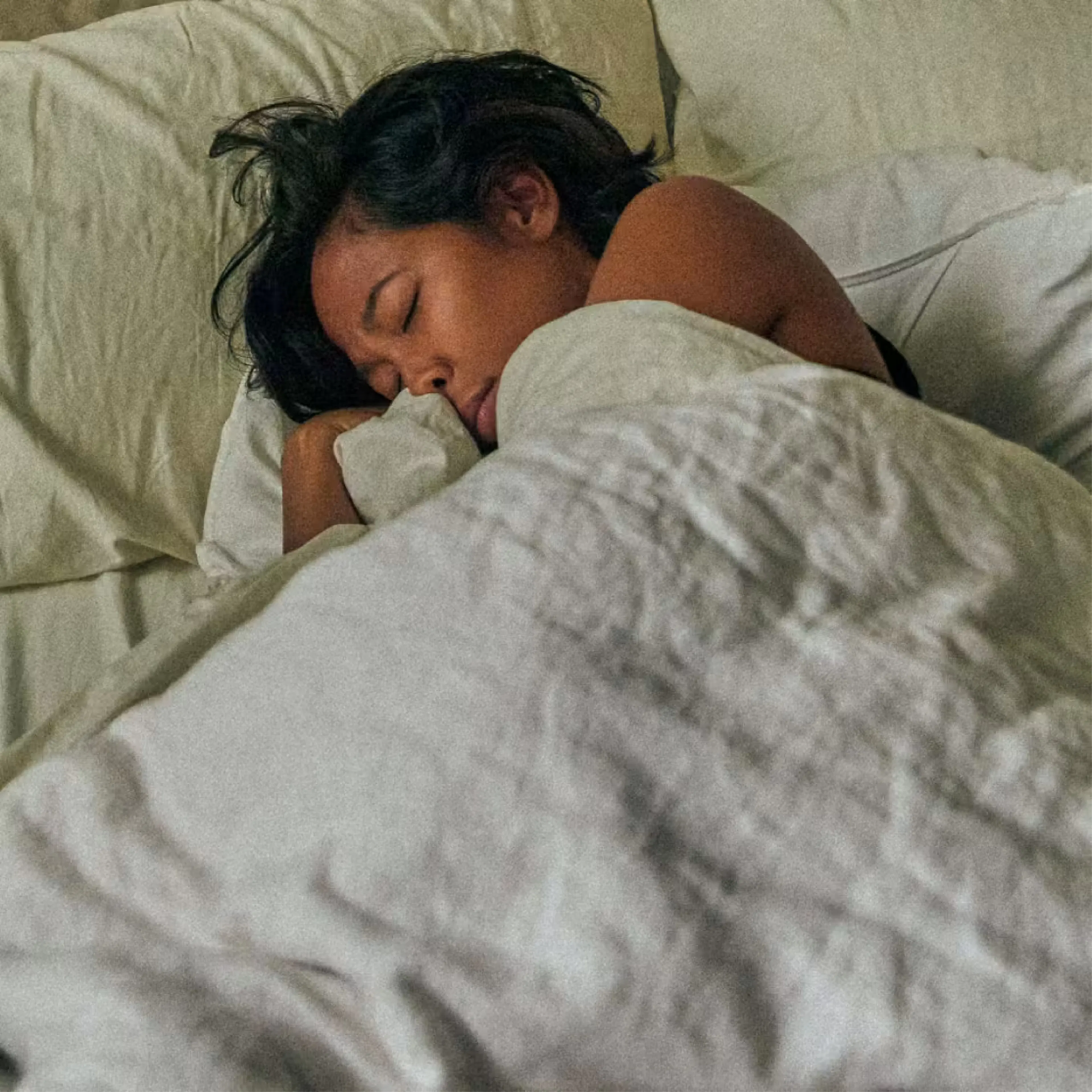 Woman sleeping peacefully under warm blanket