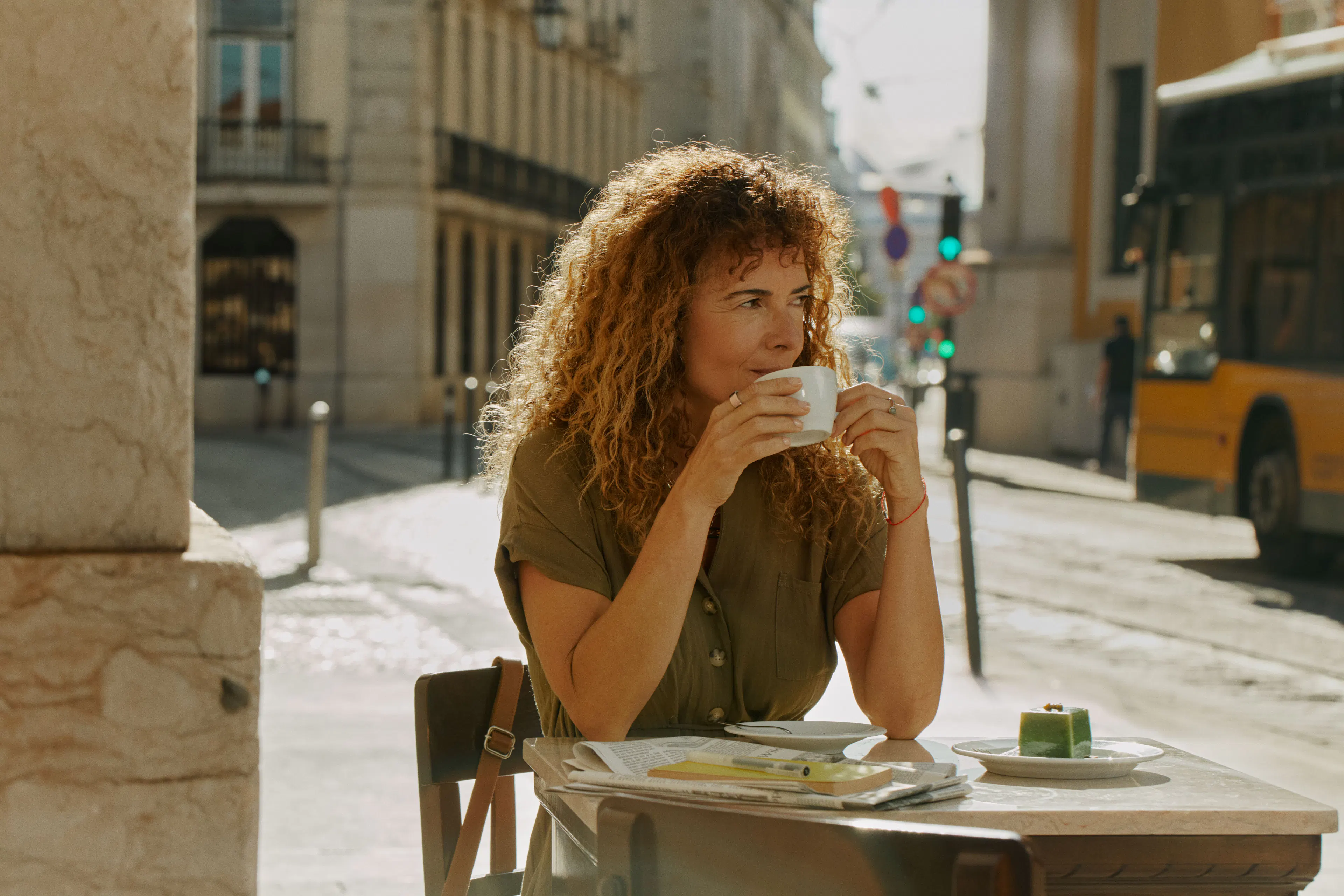 Woman sipping coffee with Oura ring